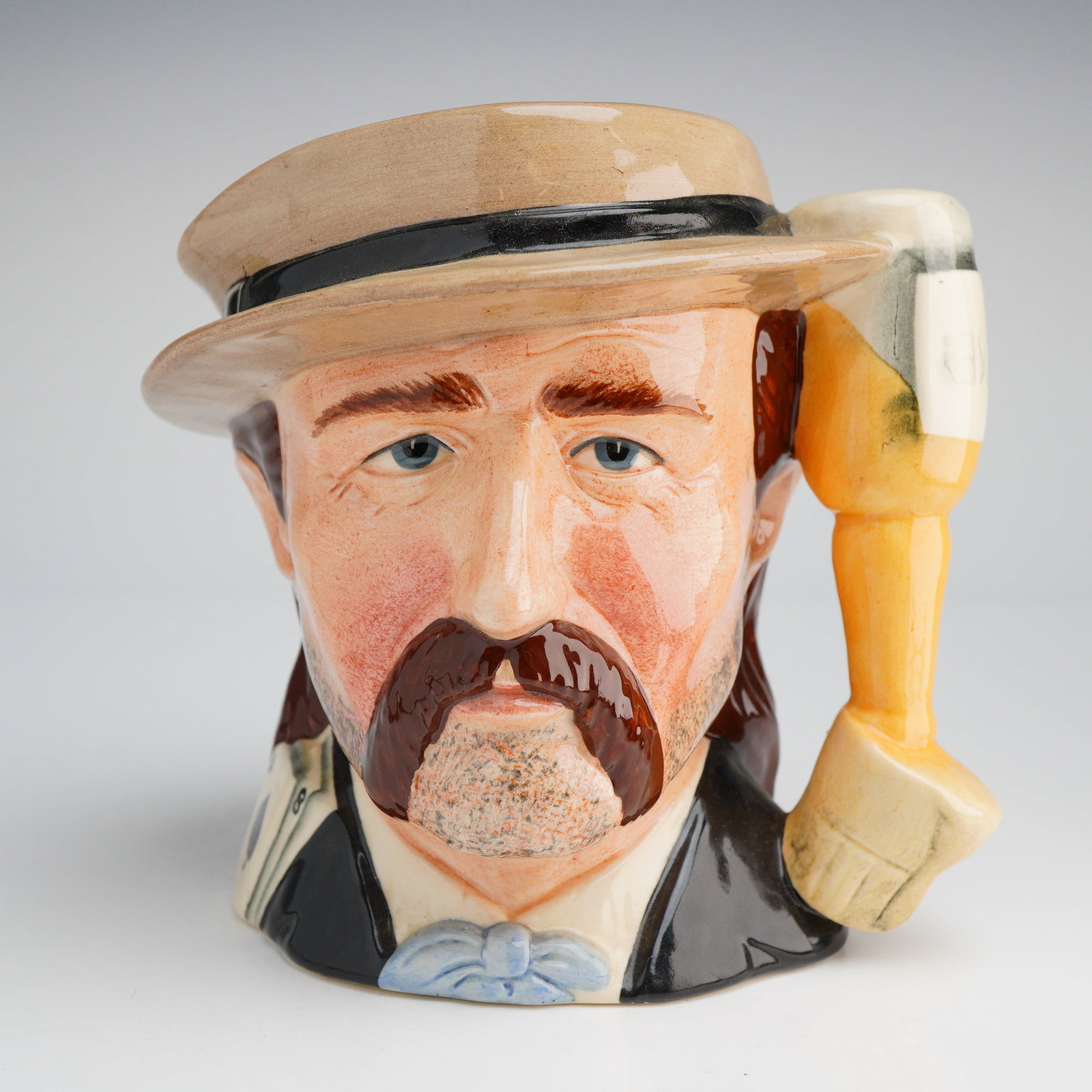 Royal Doulton Wild Bill Hickock Character Jug D6736: A Royal Doulton ceramic character jug depicting the historical figure Wild Bill Hickock, model D6736, from The Wild West Collection. This hand-painted piece features a glossy glaze and depicts the sub