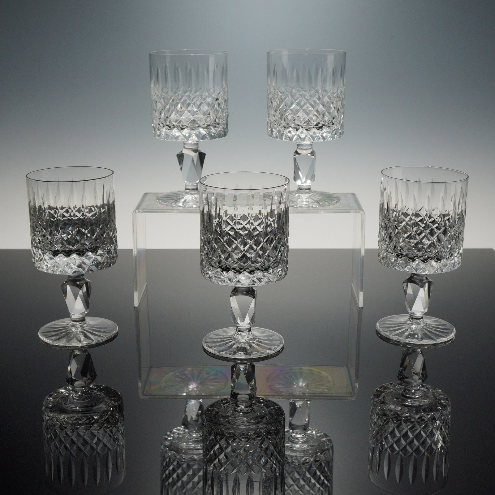 Set of Five Waterford Crystal Wine Glasses, Lismore Simplicity: This set of five glasses is crafted from heavy lead crystal in the Lismore Simplicity pattern by Waterford. Each vessel features a cylindrical bowl decorated with a lower register of deep diamond cris