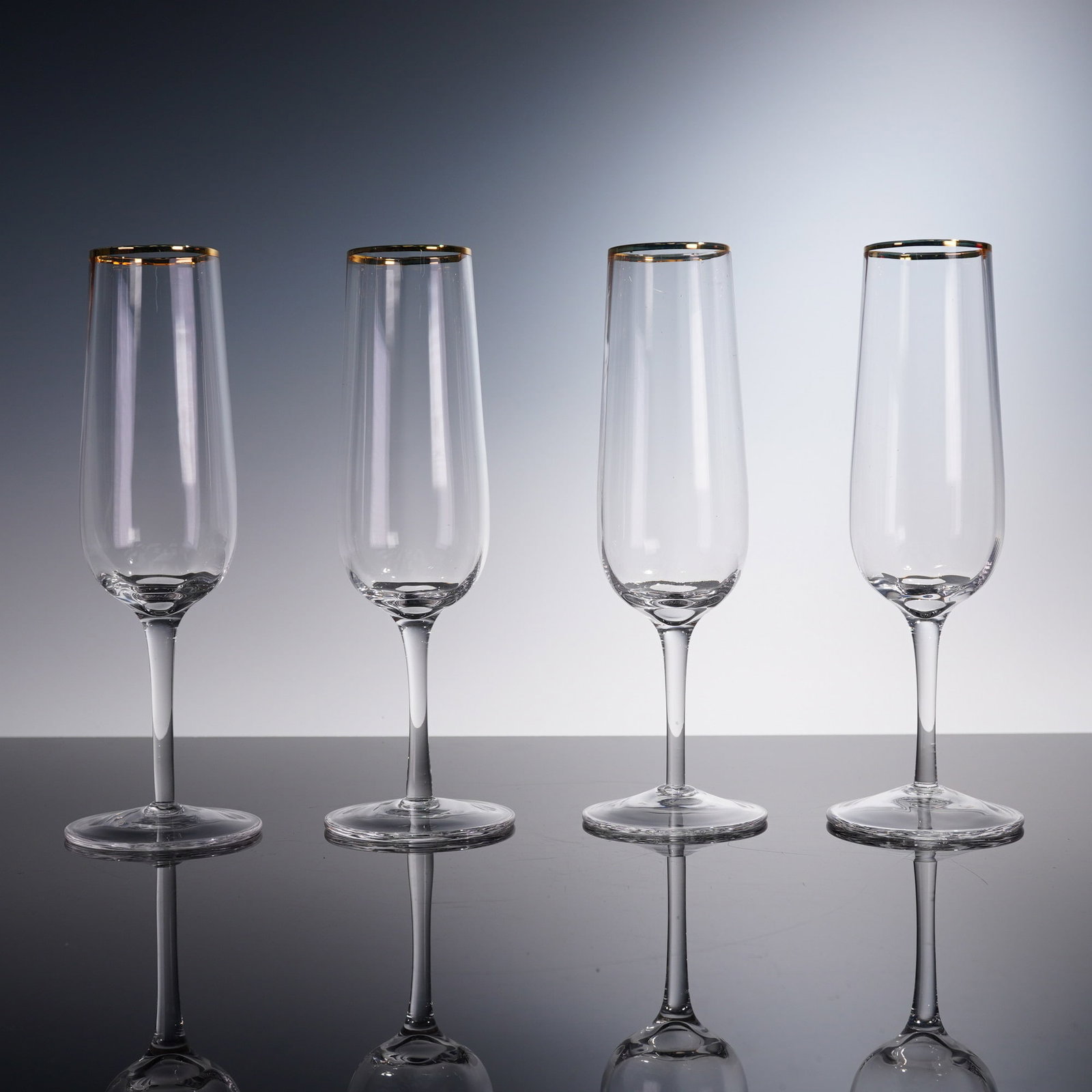 4pc Champagne Flutes, Martha Stewart Collection: This elegant 4-piece set of champagne flutes from the Martha Stewart Collection features a timeless design with slender, tapered bowls and gleaming gold rims. Perfect for toasting celebrations, these 