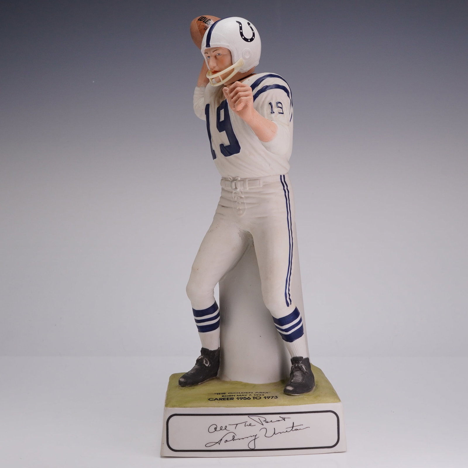 Johnny Unitas Baltimore Colts The Golden Arm Commemorative Figurine: A commemorative porcelain figurine depicting Hall of Fame quarterback Johnny Unitas in a classic passing pose. The figure is detailed with a period-accurate Baltimore Colts uniform, featuring a white 