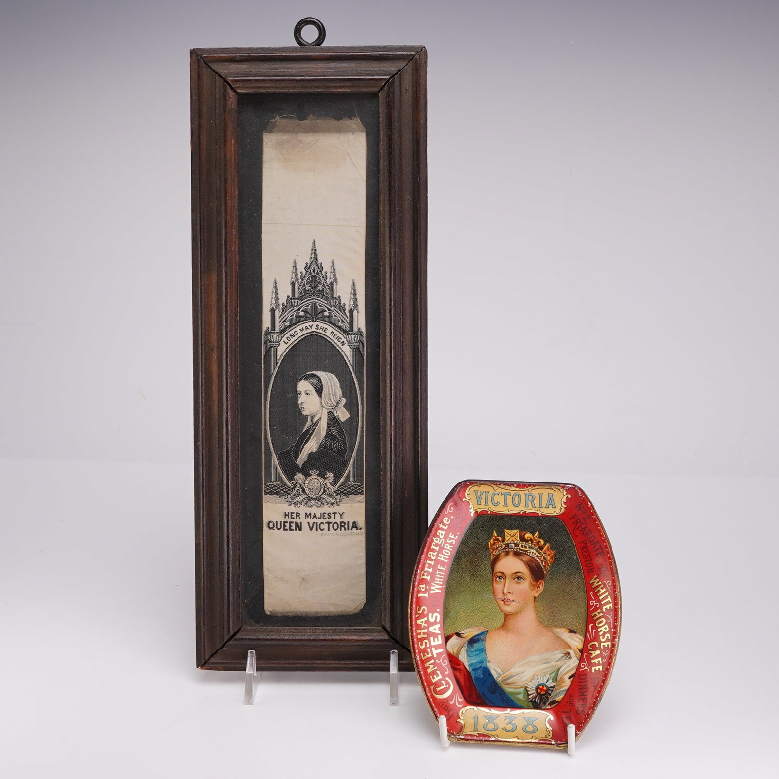 2pc Queen Victoria Pieces Including 1838 Tea Tin and Framed Image: This set of two queen-themed pieces includes a framed woven silk image and a lithographed advertising tea tin. The first item is a woven silk commemorative ribbon by Dalton and Barton, featuring a pro