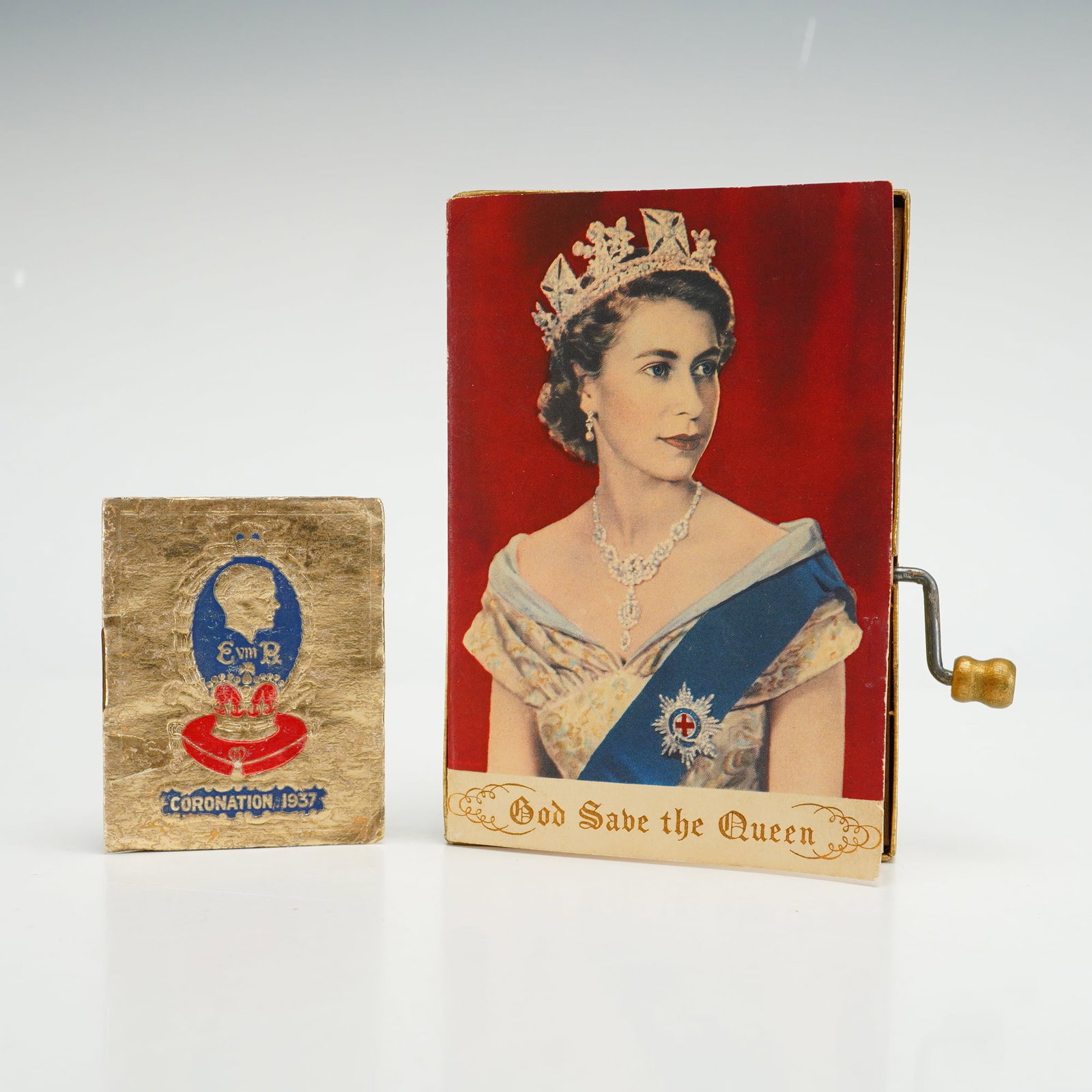 Two British Royal Coronation Commemoratives Including 1953 Queen Elizabeth II Music Box Card and: This lot consists of two items of British royal commemorative ephemera. The first item is a 1953 Queen Elizabeth II music box card created by Kaye-Kards Ltd., London. The front features a color photog