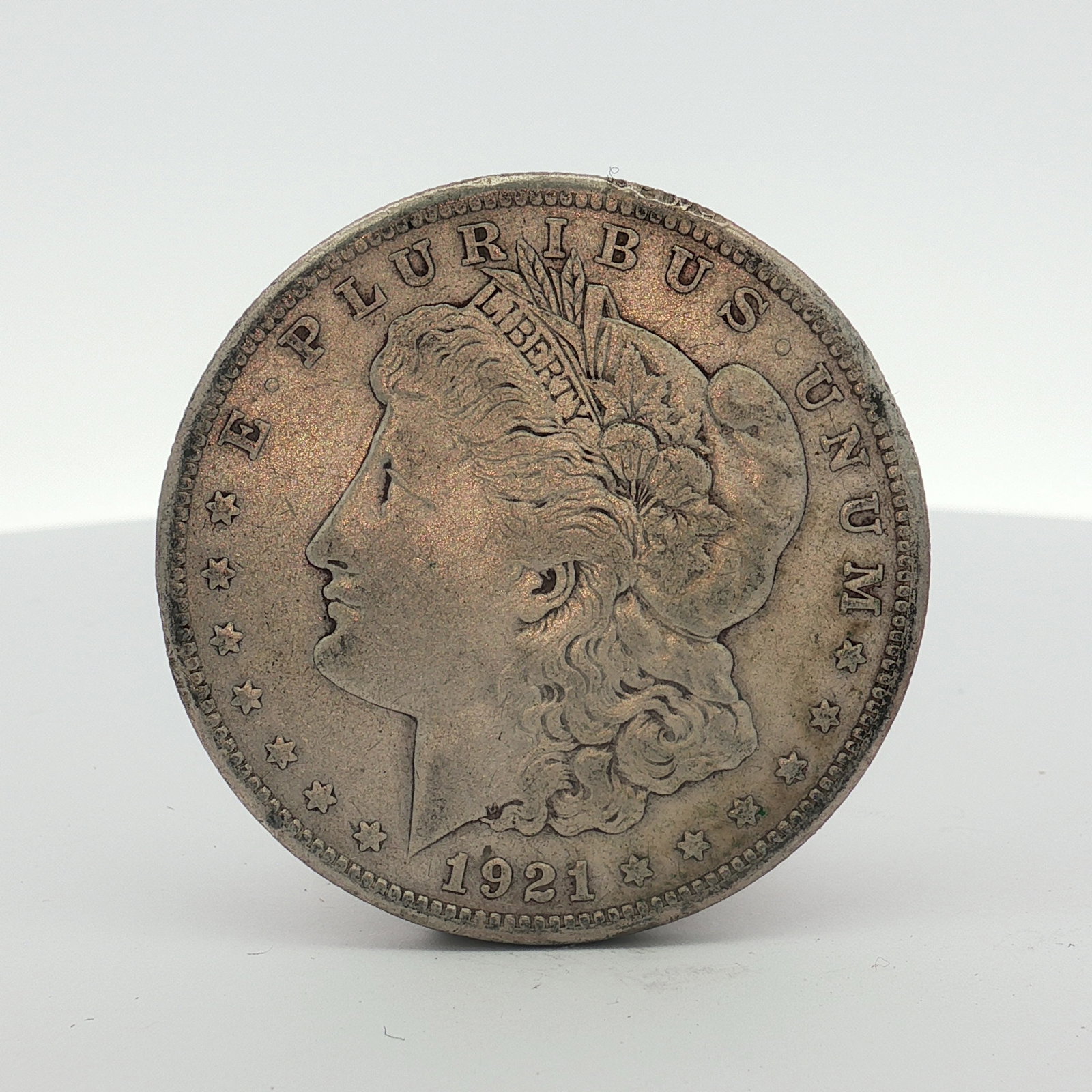 1921-S US Morgan Silver Dollar Coin Circulated: This 1921-S US Morgan silver dollar was struck at the San Francisco Mint. The coin is composed of 90 percent silver and 10 percent copper with a fineness of .900. The obverse features the date 1921 an