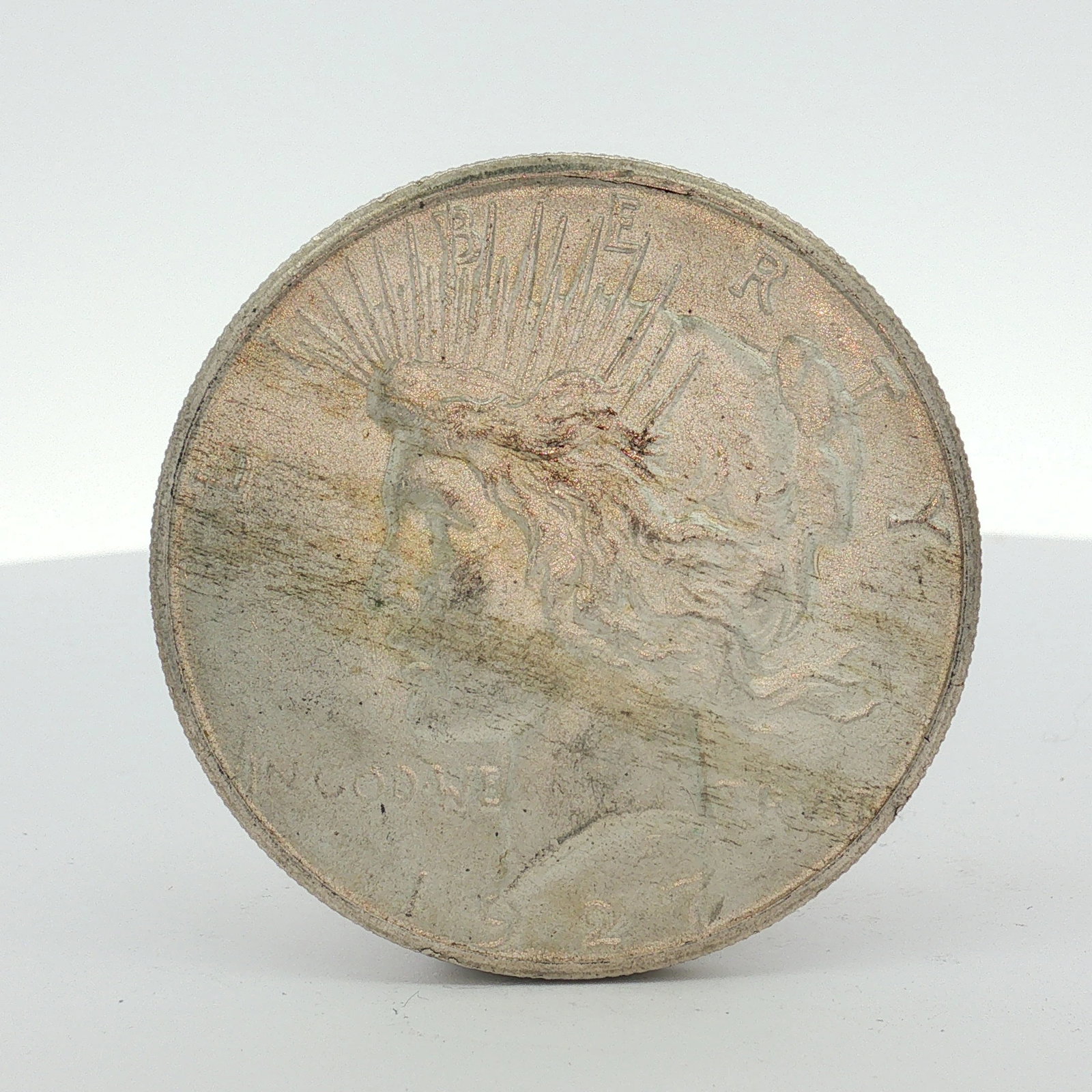 1927 US Peace Silver Dollar: The coin is composed of 90% silver and 10% copper with a fineness of .900 silver. The obverse features the Liberty head design and the reverse features the eagle on rock design. Inscriptions include L