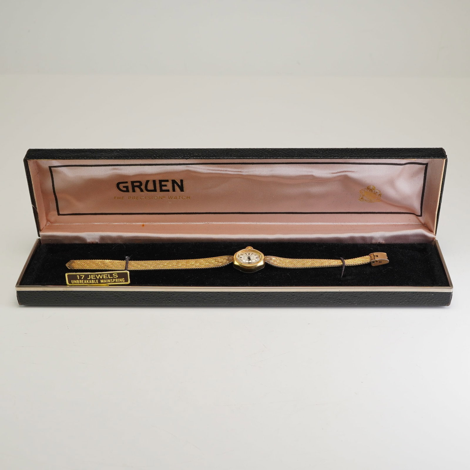 Gruen Precision Ladies Wristwatch with 10K RGP Bezel and 10K GF Band: A vintage Gruen Precision ladies' wristwatch featuring a 17-jewel manual wind movement with an unbreakable mainspring. The timepiece is constructed with a 10 karat rolled gold plate bezel and a stainl