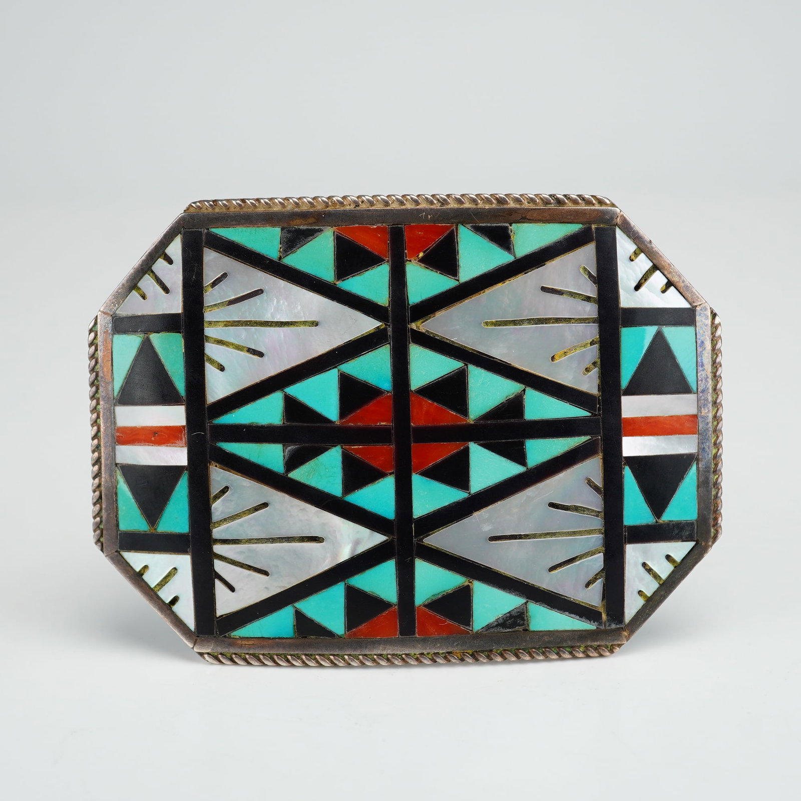 Zuni Sterling Silver Multi-Stone Channel Inlay Belt Buckle, SD Boone: This Zuni Pueblo belt buckle features intricate channel inlay work. The octagonal form is constructed from sterling silver and decorated with a complex geometric motif. The inlay is composed of turquo