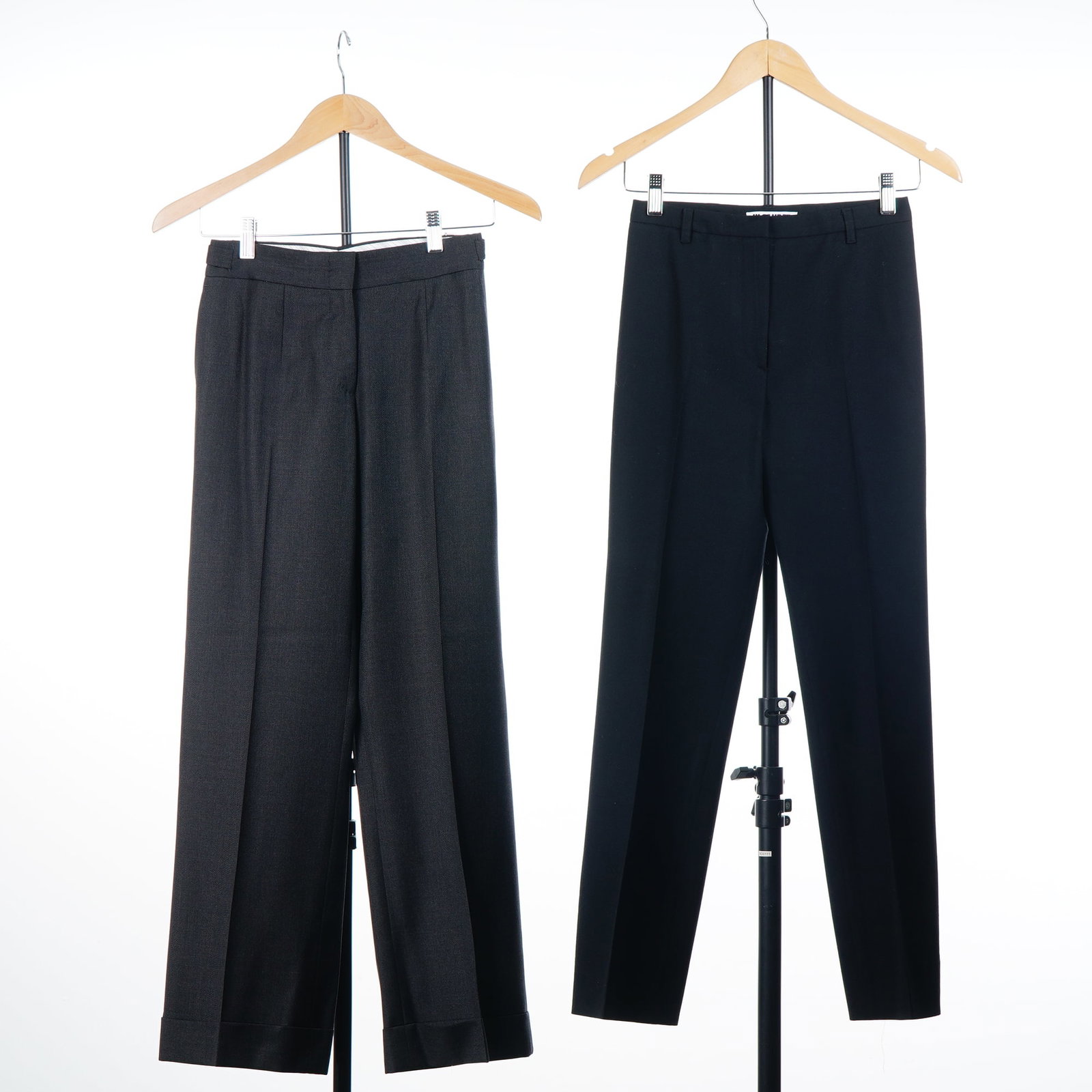 2pc Women's Designer Trousers by Pringle of Scotland and Jil Sander: This lot features two pairs of women's designer trousers. The first pair is by Pringle of Scotland, size XS, constructed in a charcoal gray wool or wool-blend suiting fabric. These wide-leg pants are 