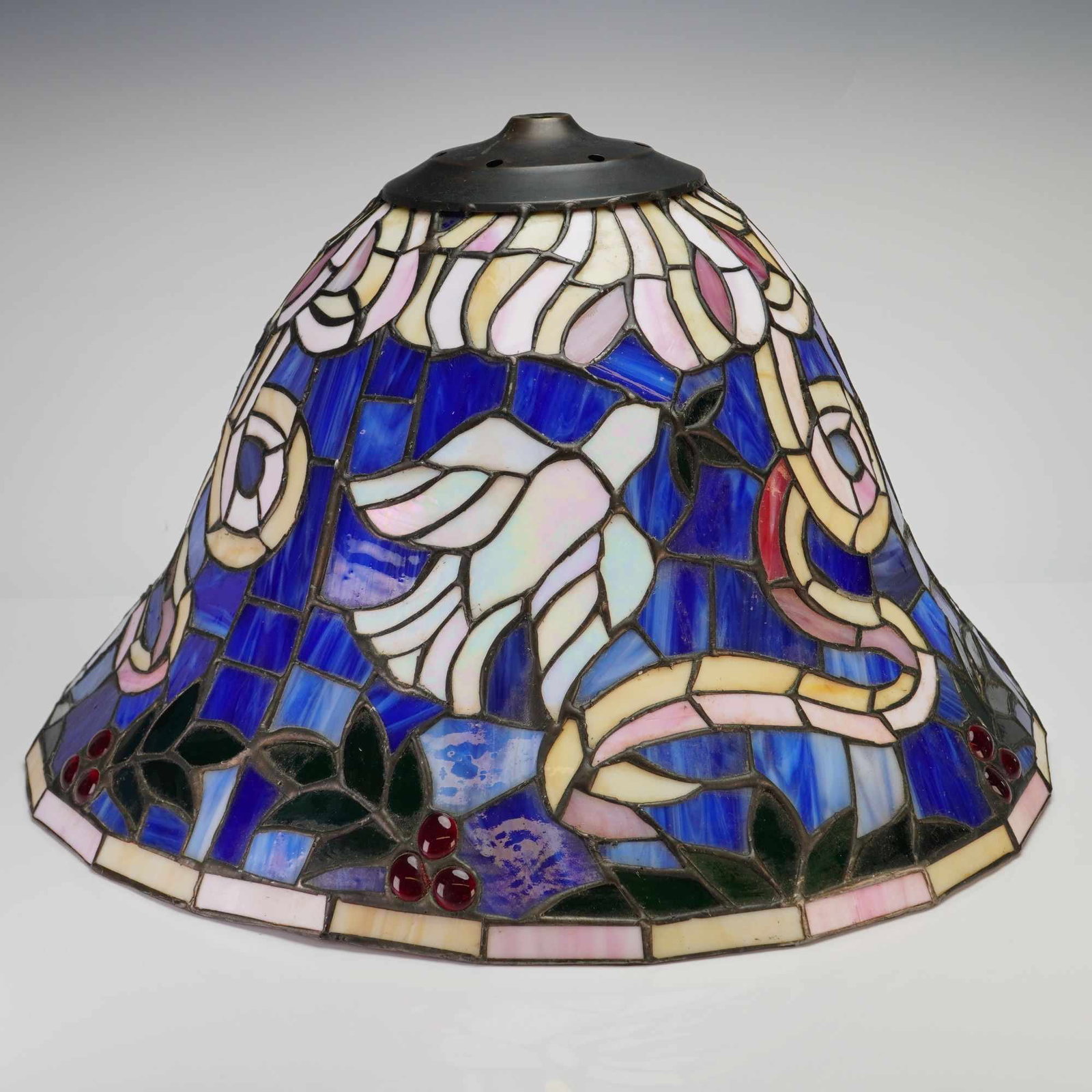 Tiffany Style Lamp Shade with Dove and Ribbon Motif: A stained-glass style lamp shade constructed in acrylic, featuring a mottled blue opalescent and slag glass-effect ground. The design depicts three white doves in flight within a field of flowing ribb