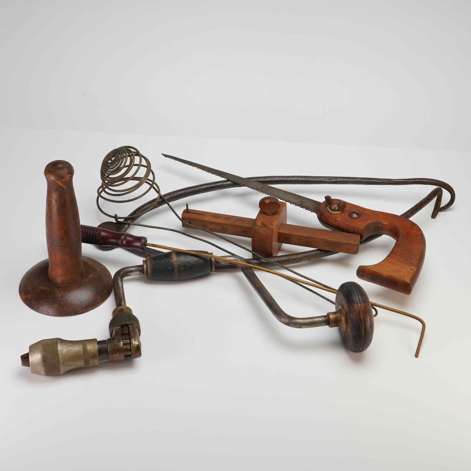 Winchester and Assorted Vintage Woodworking and Maintenance Tools, Early 20th Century: This collection of vintage woodworking and maintenance tools features a notable hardwood marking gauge by the Winchester Repeating Arms Co., bearing a legible red and black paper trade mark label. The