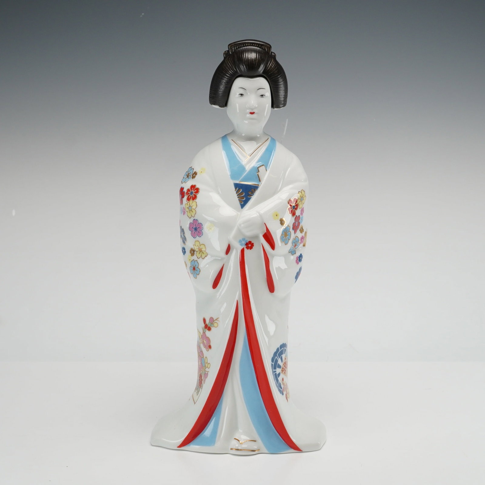 Japanese Porcelain Geisha Sake Decanter Tokkuri with Cork Stopper Hakusen Kiln: This Japanese porcelain sake decanter, also known as a tokkuri, is modeled as a standing female figure identified by markings as the historical figure Kasuga no Tsubone. Produced at the Hakusen Kiln (