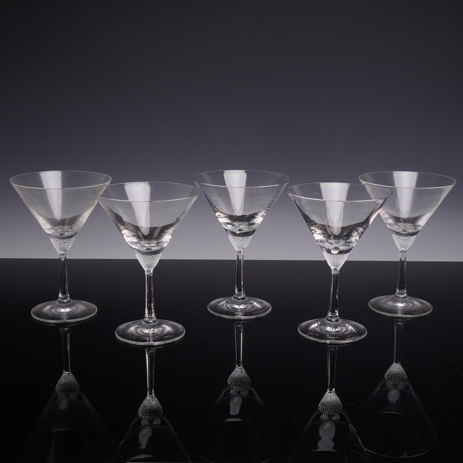 Set of 5 Villeroy & Boch Octavie Crystal Martini Glasses: A set of five crystal martini glasses in the Octavie pattern by Villeroy & Boch. Each glass features a conical V-shaped bowl supported by a distinctive knop with a diamond-point cut textured design. T
