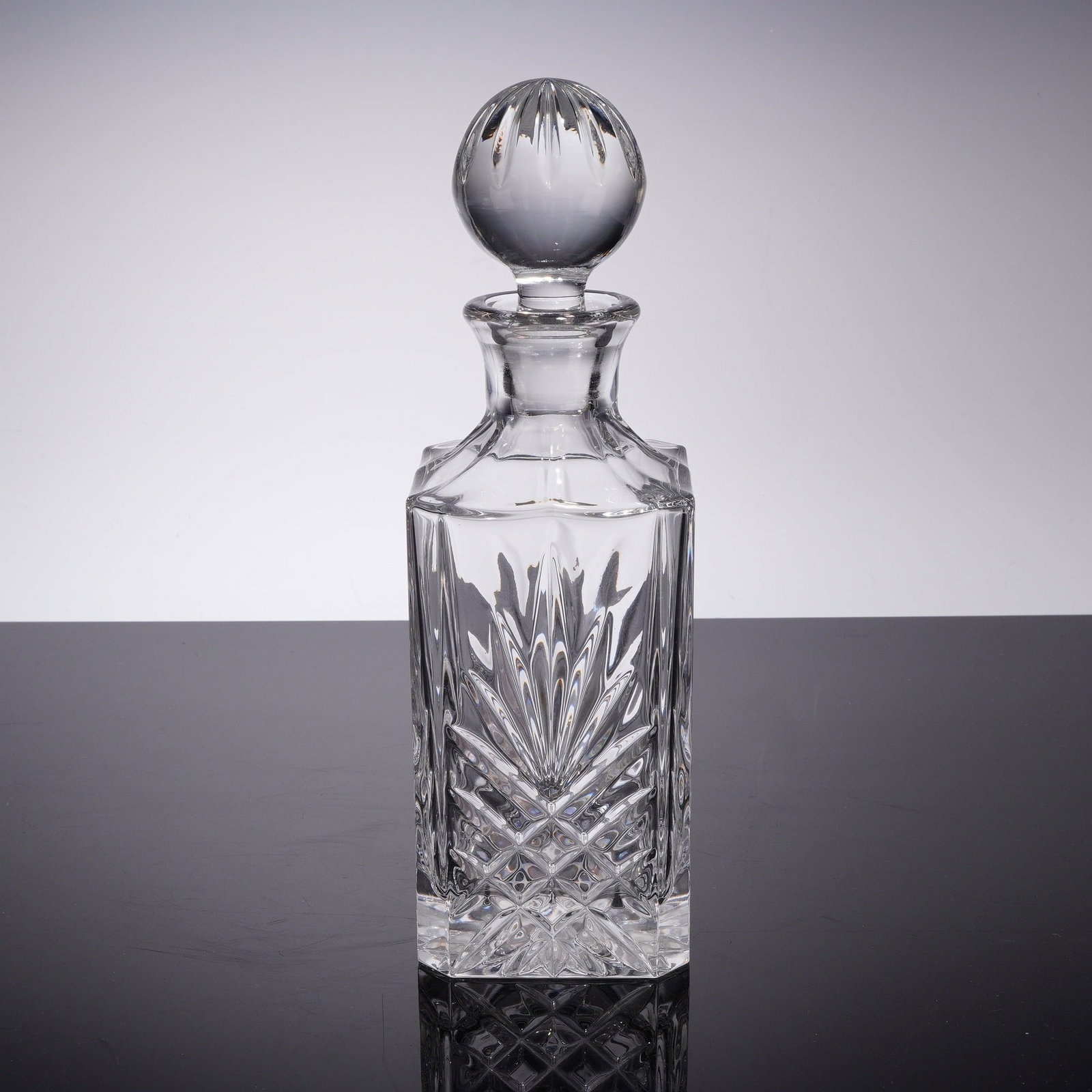 Cut Crystal Square Spirit Decanter with Stopper: This square spirit decanter is crafted from heavy lead crystal and features the Dublin pattern, characterized by deep geometric cuts. Each of the four faces displays a large central fan motif position