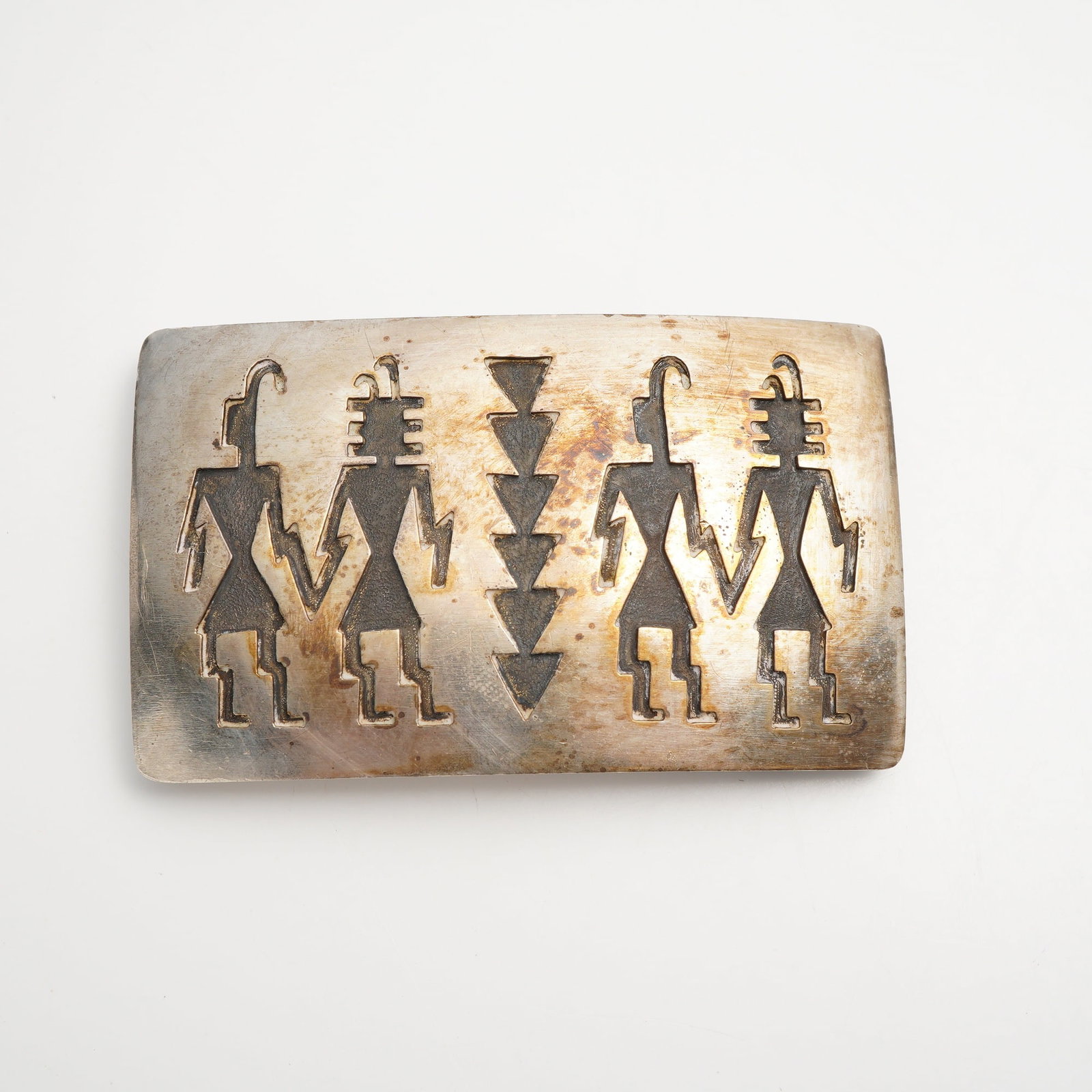 Hopi Crafts Silver Overlay Belt Buckle with Katsina Figures: This rectangular belt buckle is crafted in the Hopi silver overlay technique, featuring two layers of silver where the top layer is cut with a design and soldered to a bottom plate. The recessed areas