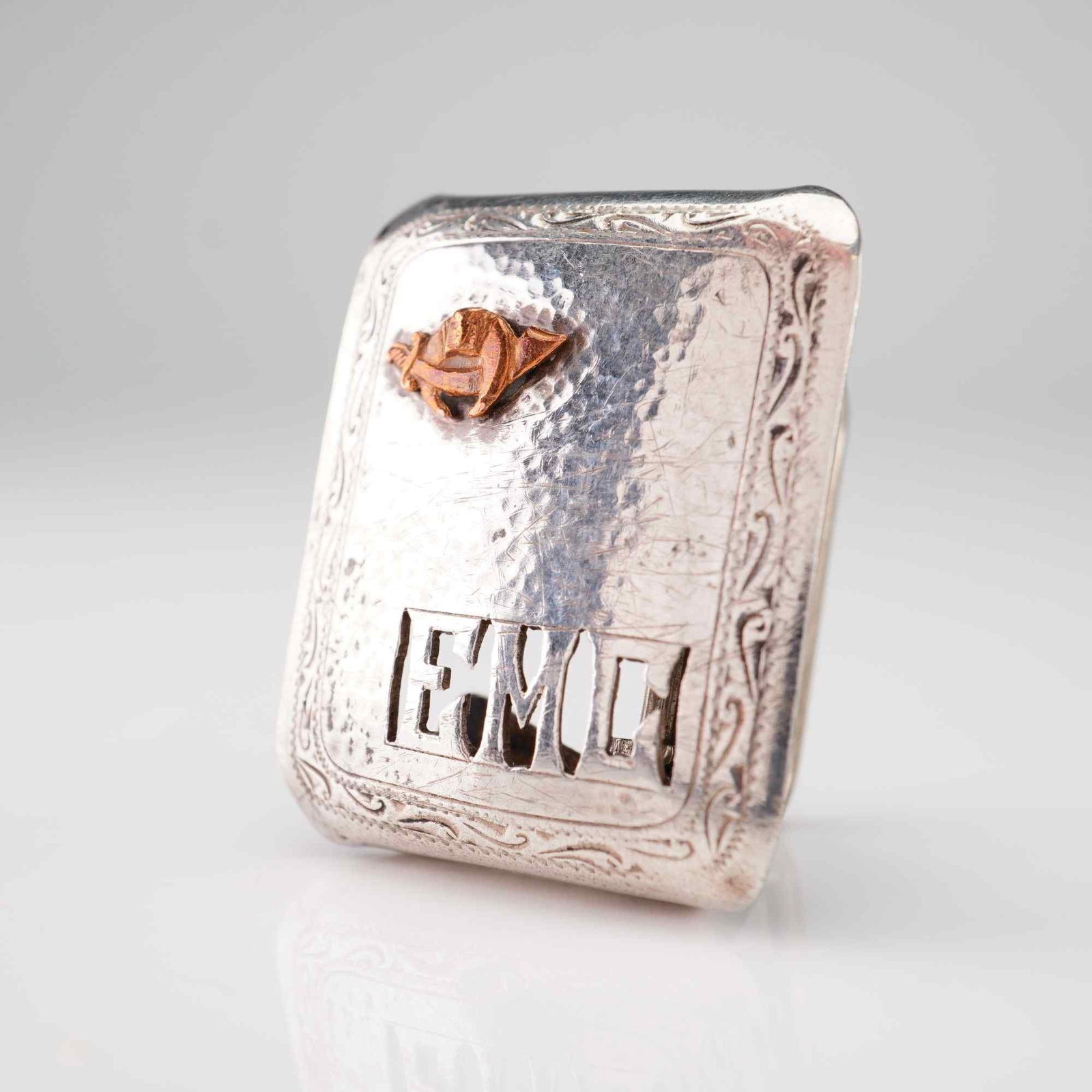 Sterling Silver Shriners Fraternal Box Belt Buckle with Pierced Initials: This box-style belt buckle is crafted from sterling silver and features a hand-hammered martele texture across the face. A decorative scroll and floral border is engraved around the perimeter. The low