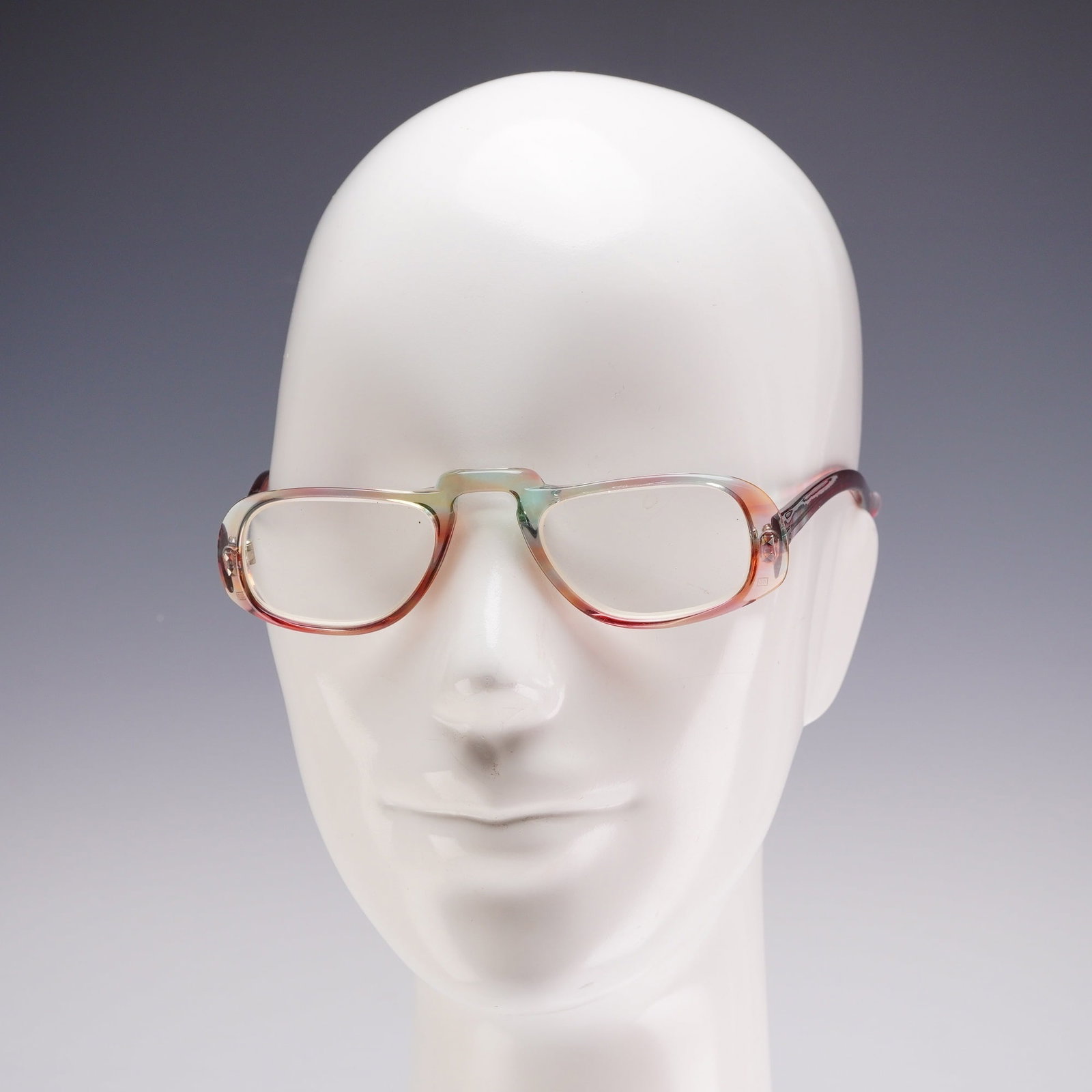Givenchy Unico Vintage Multicolored Translucent Acetate Eyeglass Frames: A pair of Givenchy eyeglass frames manufactured in France by Unico Frame. The frames are composed of translucent acetate featuring a marbled swirl pattern in shades of burgundy, teal, and pale green. 
