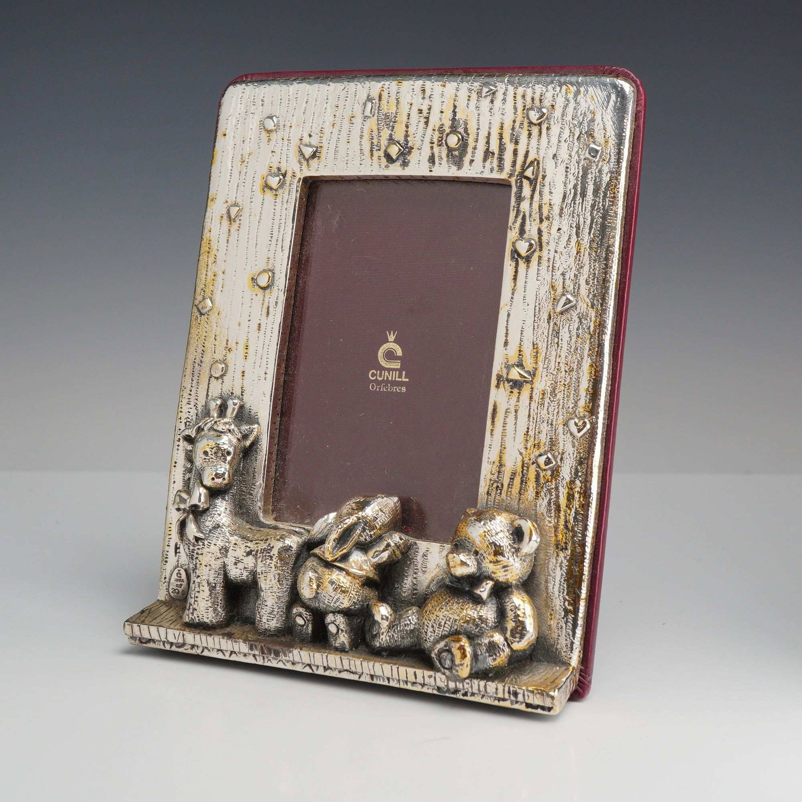Cunill Orfebres Sterling Silver Nursery Photo Frame with Teddy Bear Rabbit and Giraffe: A sterling silver photo frame by Cunill Orfebres featuring a whimsical nursery-themed design. The frame front is finished with a deeply textured bark-like pattern accented by embossed hearts and geome