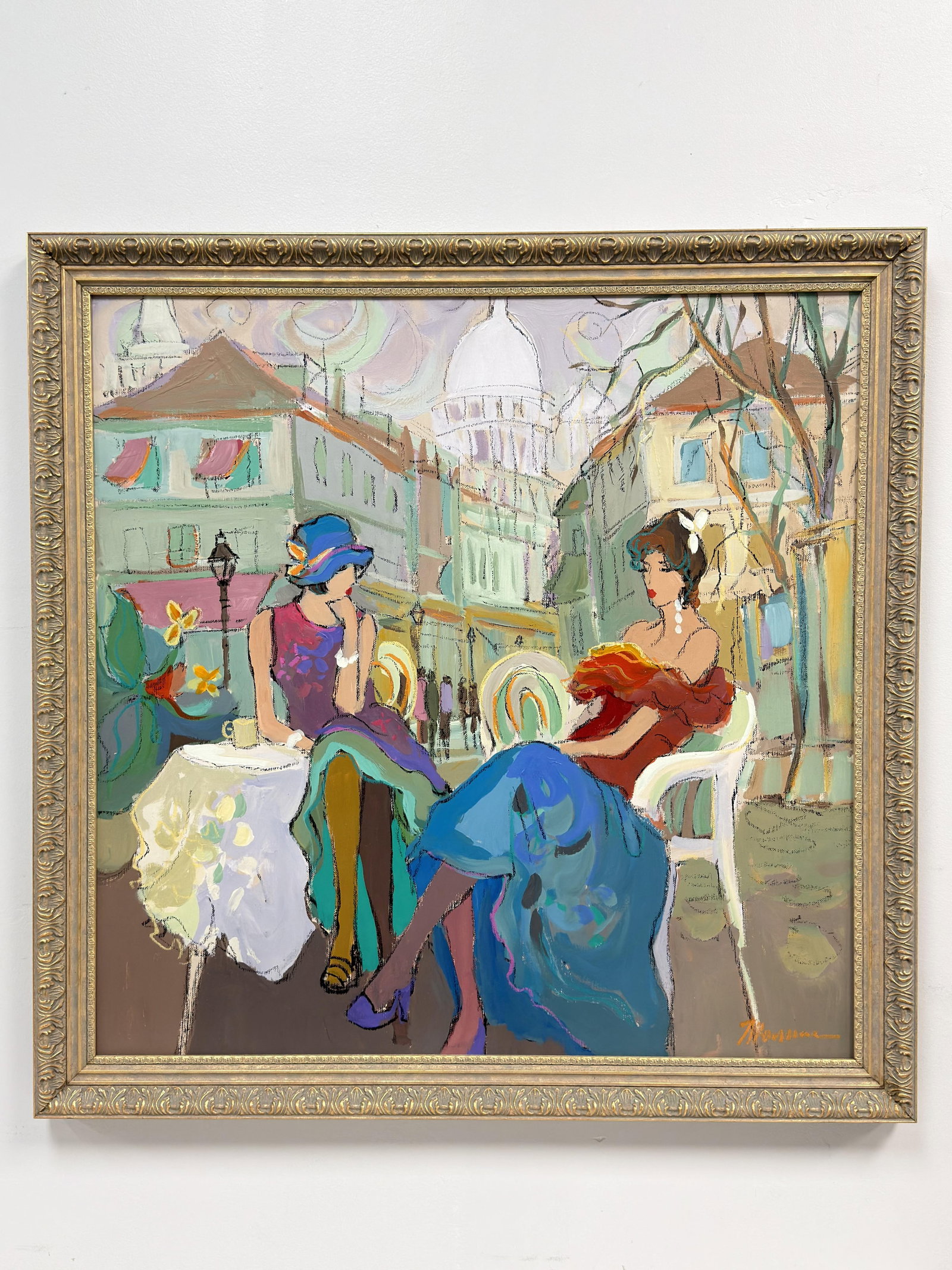 Isaac Maimon (Israeli, b. 1951) Mixed Media Original Painted Canvas, Cafe Scene: This original mixed media painting on canvas is by Isaac Maimon. The contemporary figurative work depicts two women in stylized attire seated at an outdoor cafe table. The background illustrates a cit