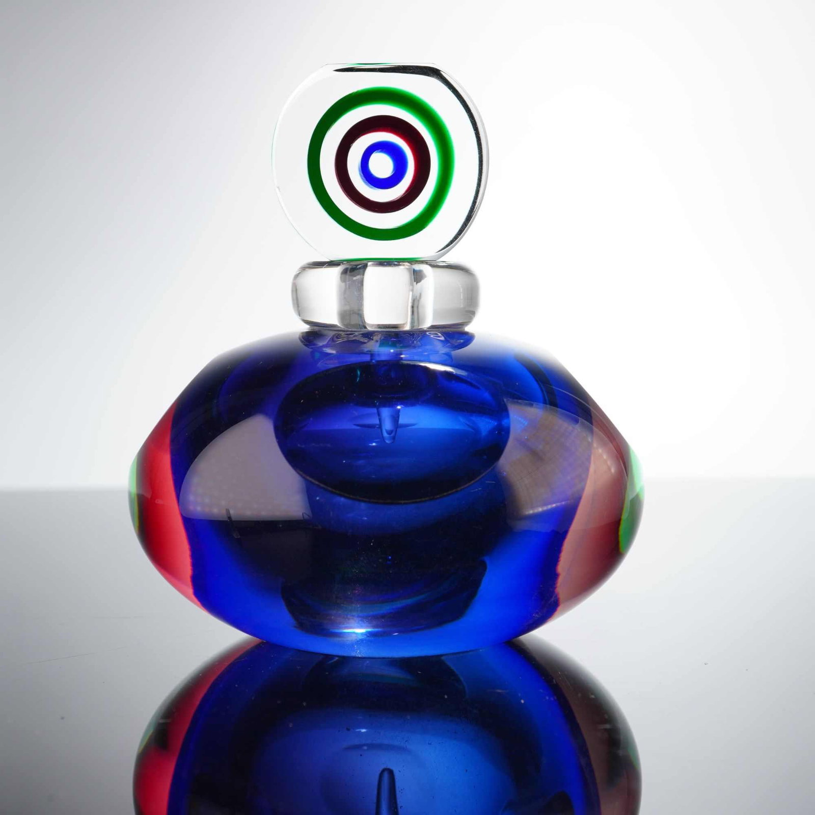 Oball Murano Glass Sommerso Jewel-Toned Round Perfume Bottle, Signed: Featuring a heavy, thick-walled squat ovoid form. The design showcases a deep cobalt blue core encased within clear glass, accented by vertical bands of translucent red and green integrated into the s