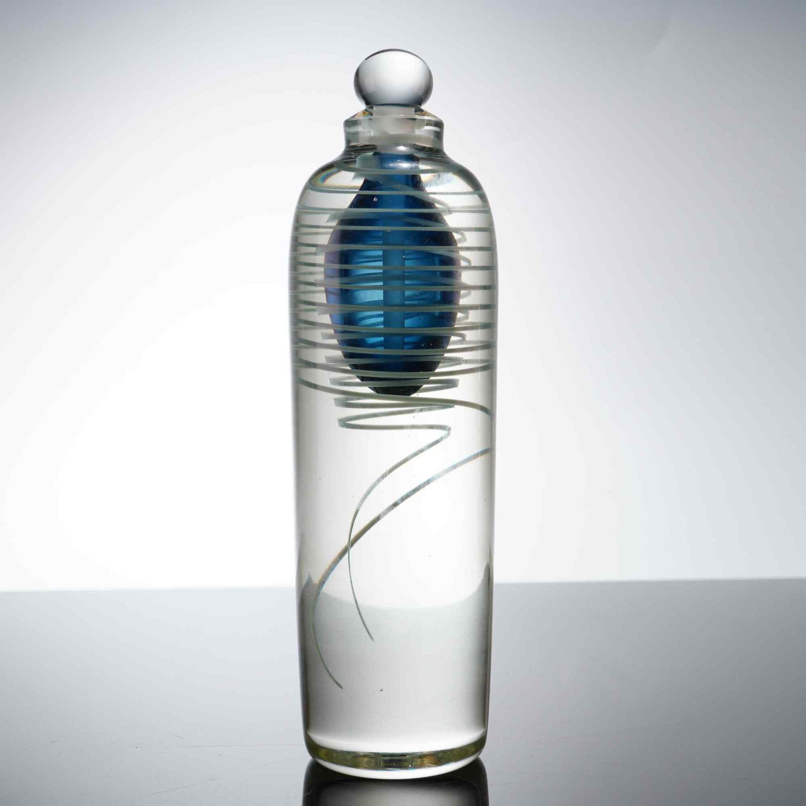 John Nickerson Studio Art Glass Scent Bottle and Stopper: This hand-blown art glass scent bottle is the work of artist John Nickerson, dated 1997. The vessel features a tall, cylindrical clear glass body with rounded shoulders and a short neck. It is created