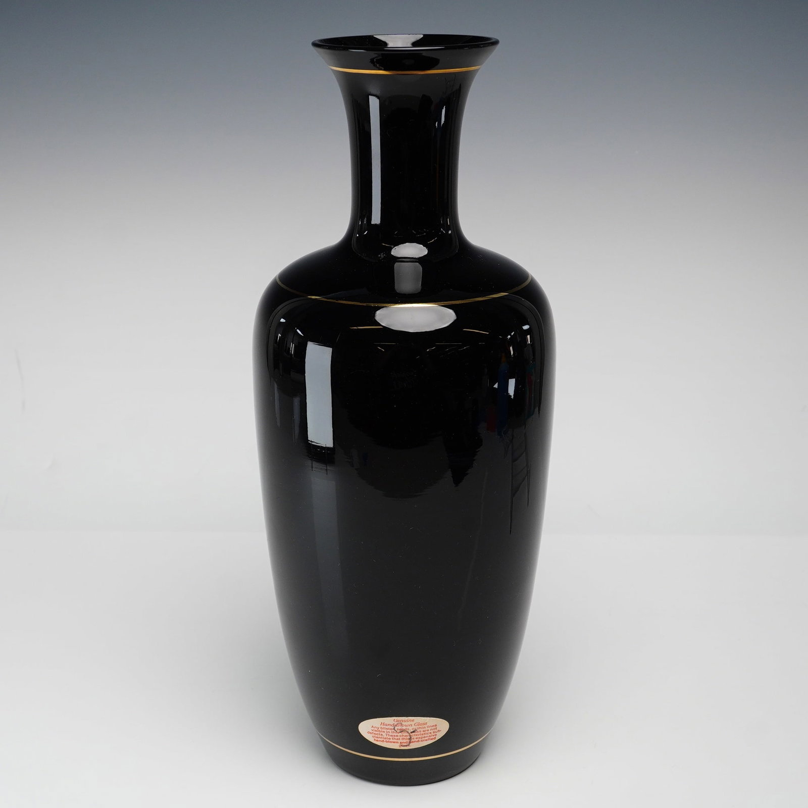 Hand-Blown Mirror Black Glass Baluster Vase with Gilt Bands: A hand-blown decorative glass vase produced in the mirror black style, featuring a deep opaque black color often referred to as black amethyst glass. The vessel is designed in a tall baluster form cha