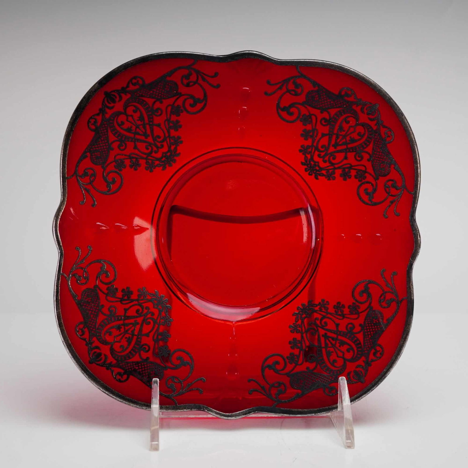 Vintage American Ruby Red Glass Scalloped Underplate with Silver Overlay: This square lobed dish is a fine example of American decorative glass from the early to mid-20th century, likely produced during the Depression era (c. 1920-1940). The vibrant ruby red body is made of