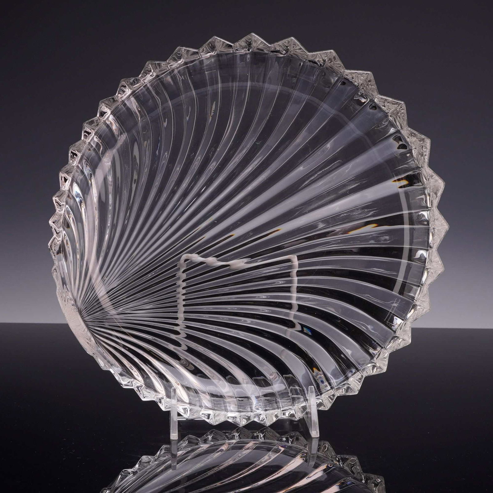 Villeroy & Boch Lead Crystal Scalloped Shell Serving Bowl: This lead crystal serving bowl is fashioned in the form of a stylized shell, in the Platano pattern by Villeroy & Boch. The design features a dramatic radial arrangement of deep, swirling ribs that or