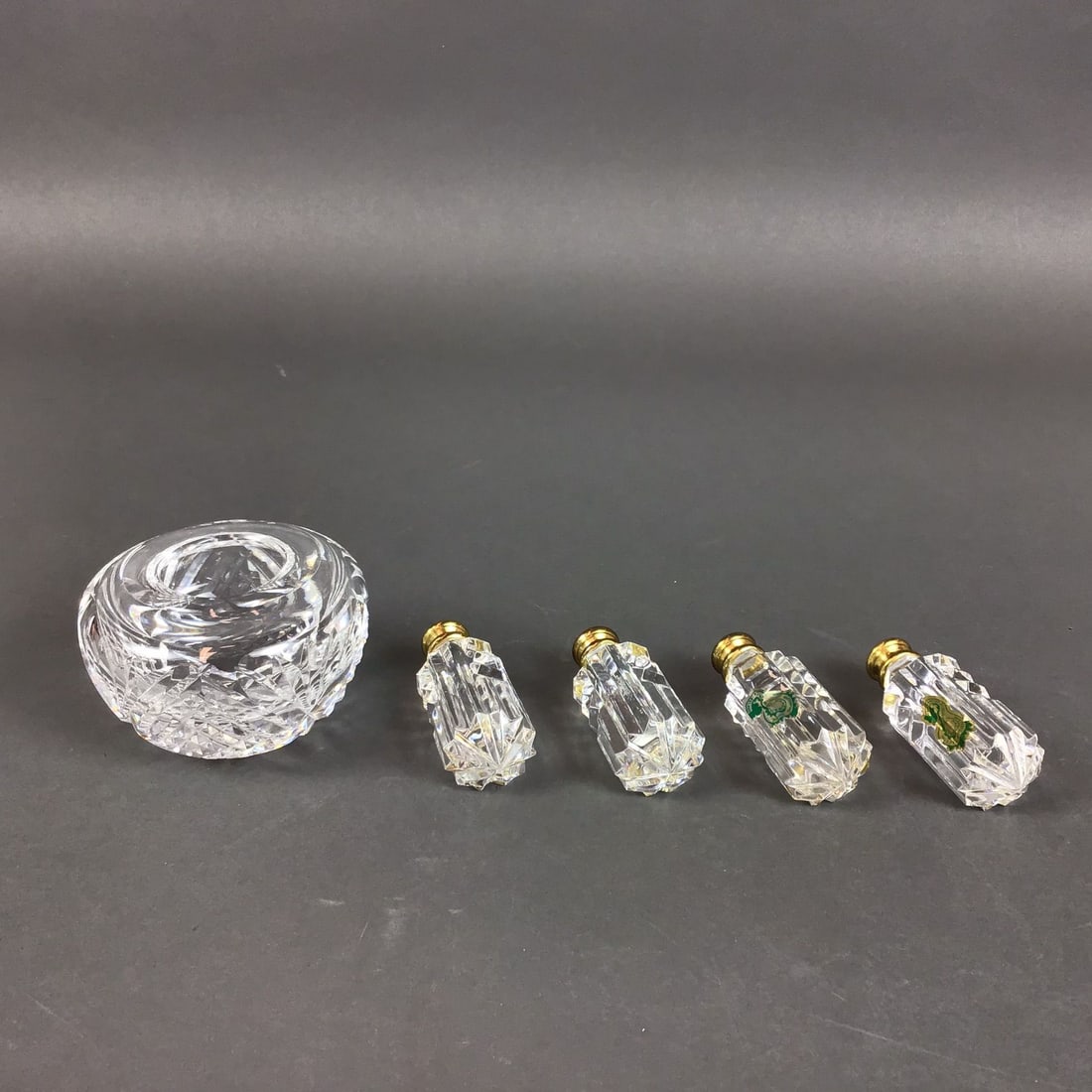 5pc Waterford Cut Lead Crystal Finials and Paperweight: This lot includes a group of Waterford lead crystal decorative pieces, comprising four finials and one dome-form hollow paperweight. The paperweight has a squat circular form with geometric diamond-cu