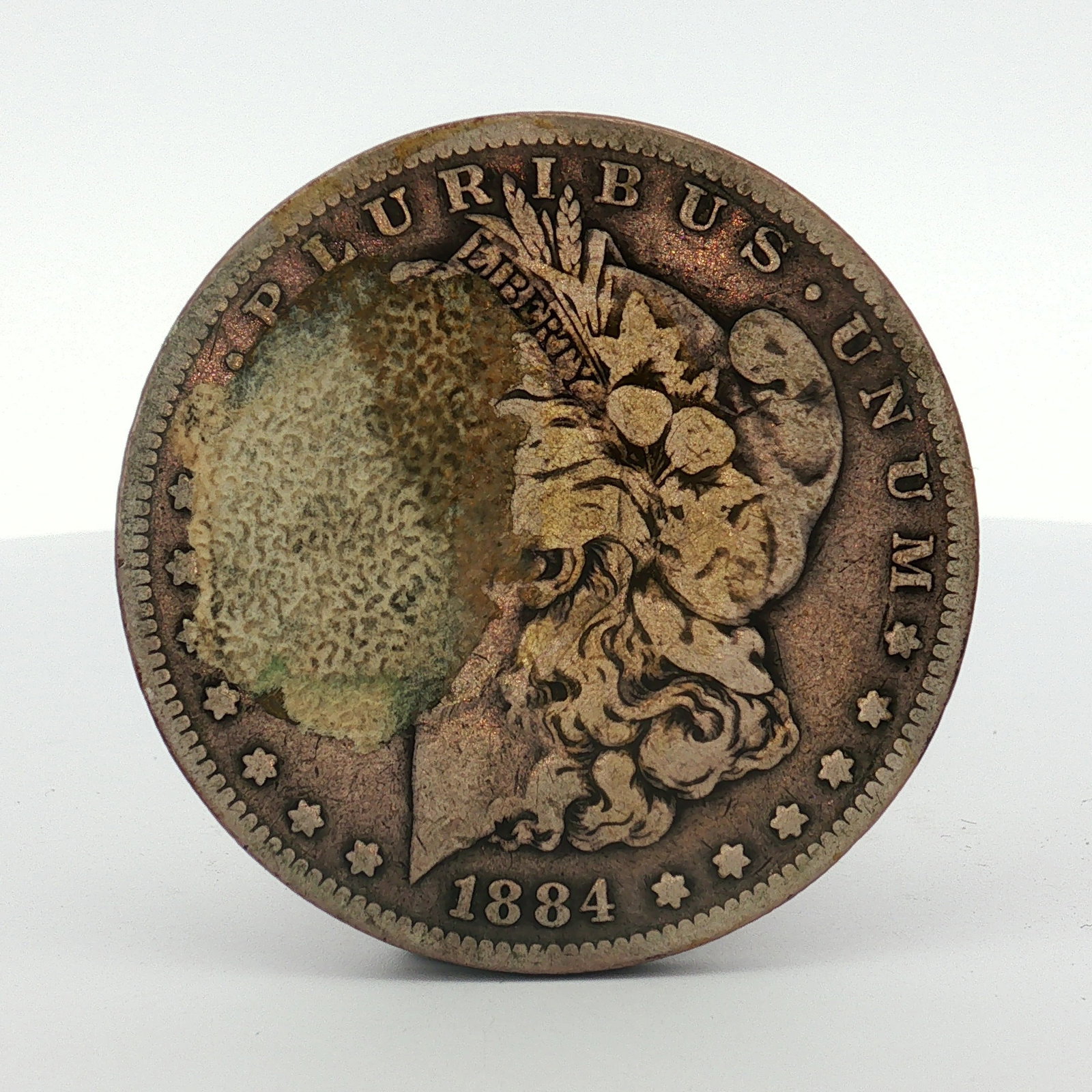 1884-S US One Dollar Morgan Silver Dollar, Circulated: US Morgan silver dollar struck at the San Francisco Mint, cataloged as KM# 110. The coin is composed of 90% silver and 10% copper. It features the Morgan dollar obverse and reverse design types. The S