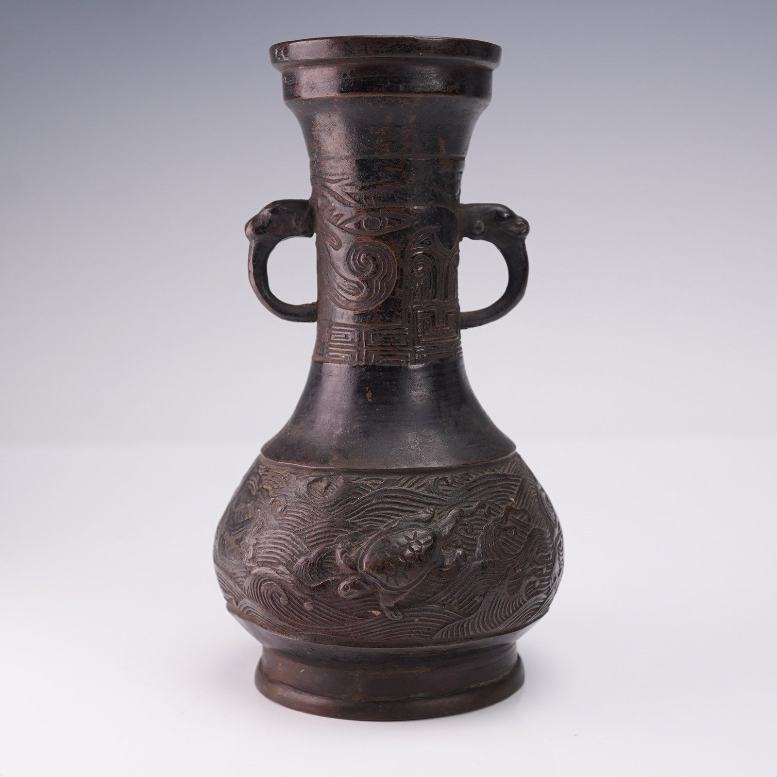 Chinese Ming Dynasty Small Bronze Sea Turtle Relief Vase: Chinese Ming Dynasty small bronze vase featuring two handles in the form of possible lion heads or dragon heads. The body of the vase is decorated with an engraved ocean motif and relief representatio