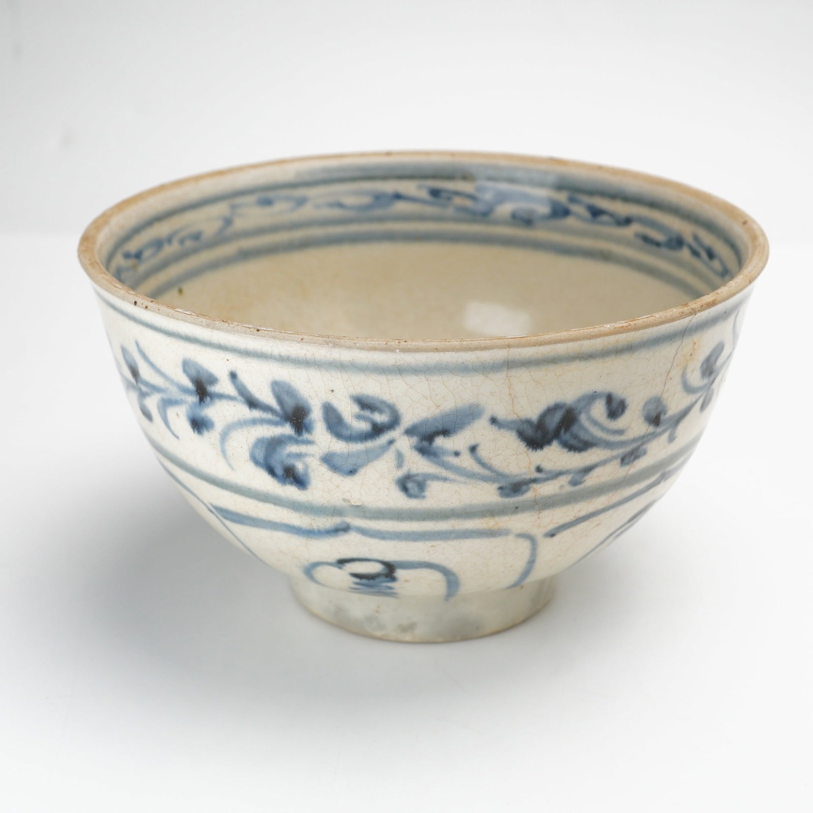 Blue and White Porcelain Bowl, Floral Design, Ming Dynasty, Brown Slip Foot: A white porcelain bowl with blue floral pattern and border in the interior and exterior. The foot bears a brown slip. Dimensions 6.25"W x 3.5"H Weight 1.10 lb