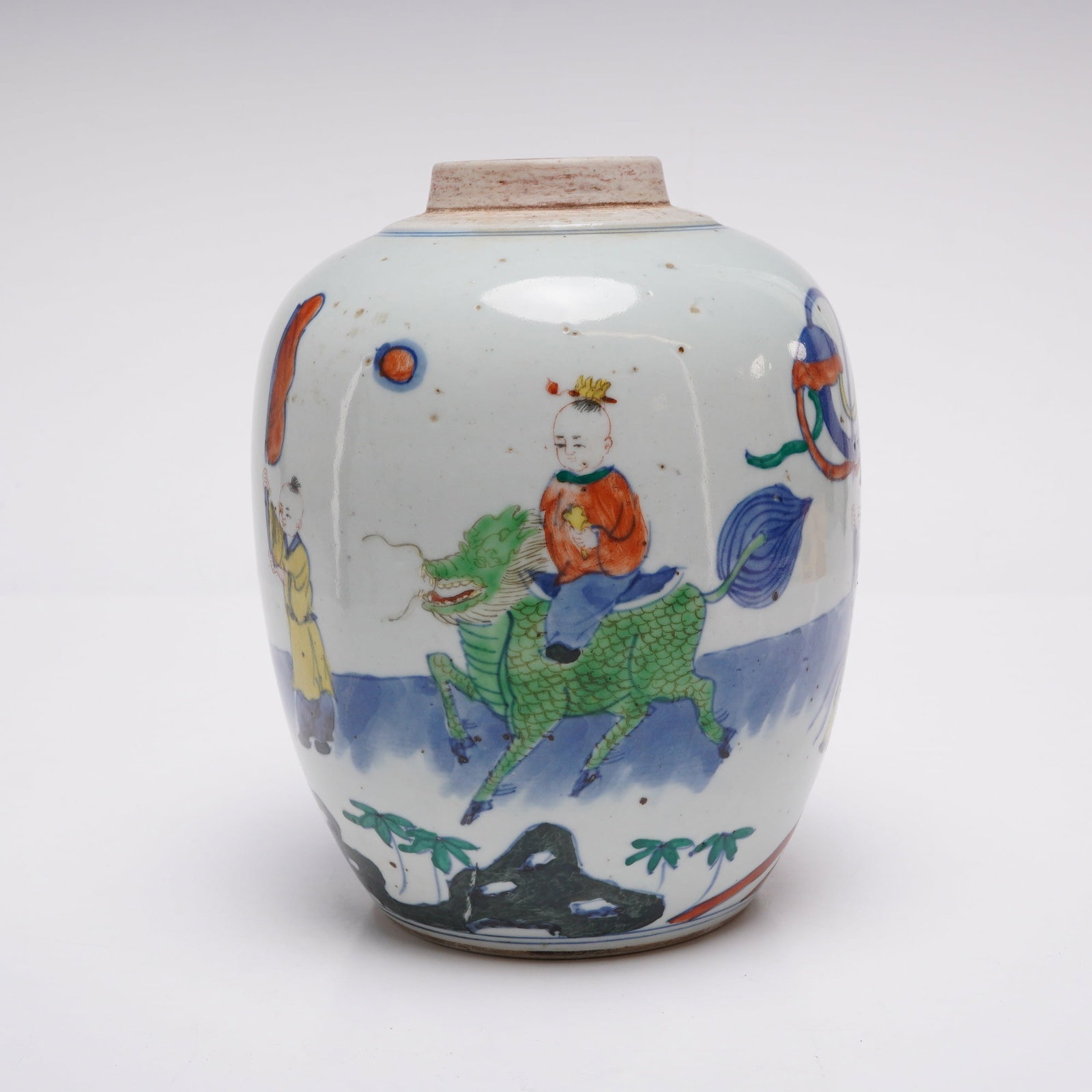 Chinese Doucai Porcelain Jar, Procession, Boy on Qilin: A Chinese Doucai porcelain jar decorated with a hand-painted scene depicting a procession and a boy riding a Qilin. The underside has a double circle mark. Dimensions 5.5"W x 6.5"H Weight 2.70 lbs