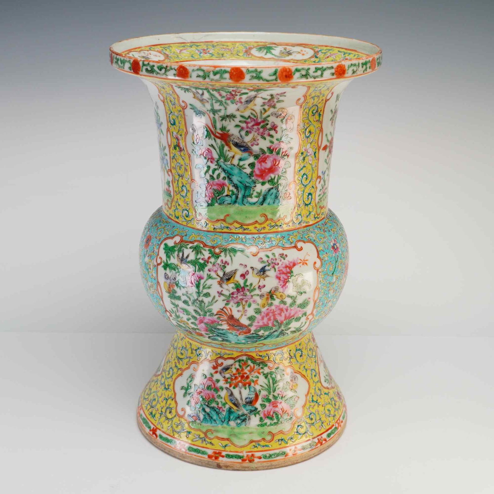 Large Chinese Famille Rose Porcelain Gu Vase, Flowers and Birds: A large drilled Chinese porcelain Gu vase with famille rose decoration in yellow, blue, red, and green, featuring floral and bird motifs. Dimensions 10"W x 16"H Weight 9 lbs 10 oz