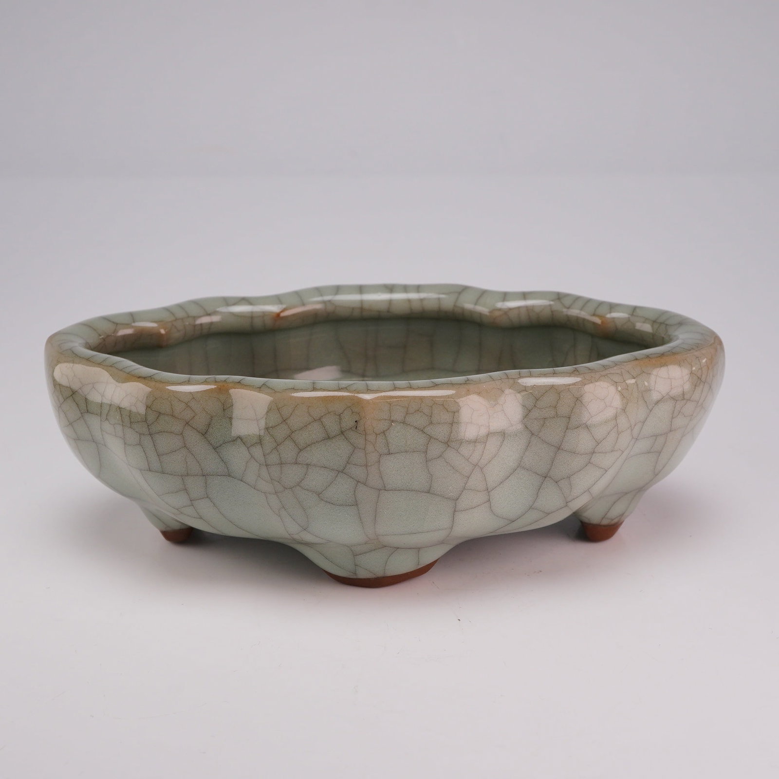 Chinese Guan Ware Glazed Lobed Incense Burner: A glazed Chinese Guan ware vessel with a gray-green hue and delicate crackles, featuring a scalloped rim and standing on four feet. Dimensions 5.5"L x 3.5"W x 1.5"H Weight 11.0 oz