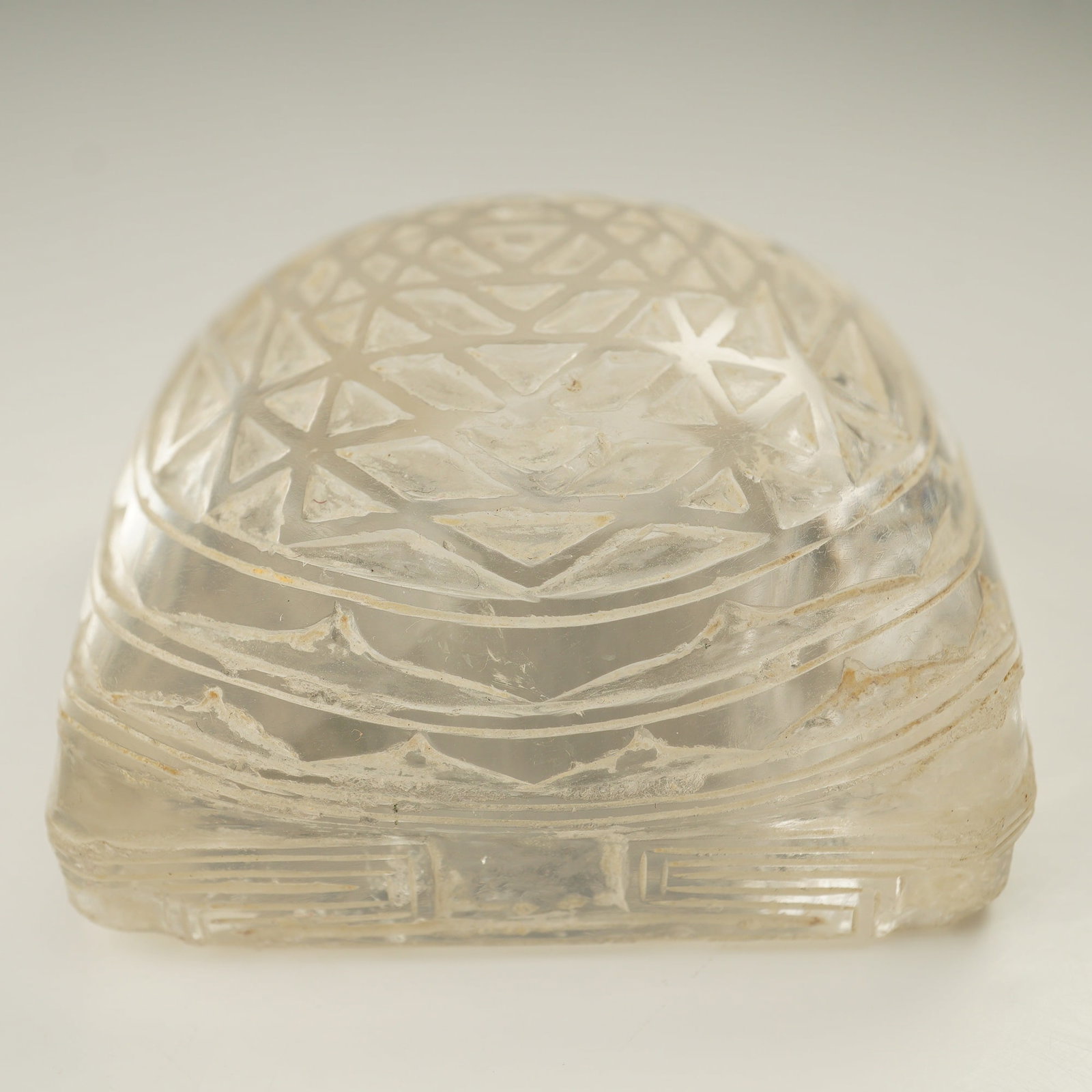 Indian Yantra Rock Crystal: A carved rock crystal yantra featuring a complex geometric design composed of interlocking triangles within concentric circles, used in Indian Tantric traditions as a visual instrument for meditation,
