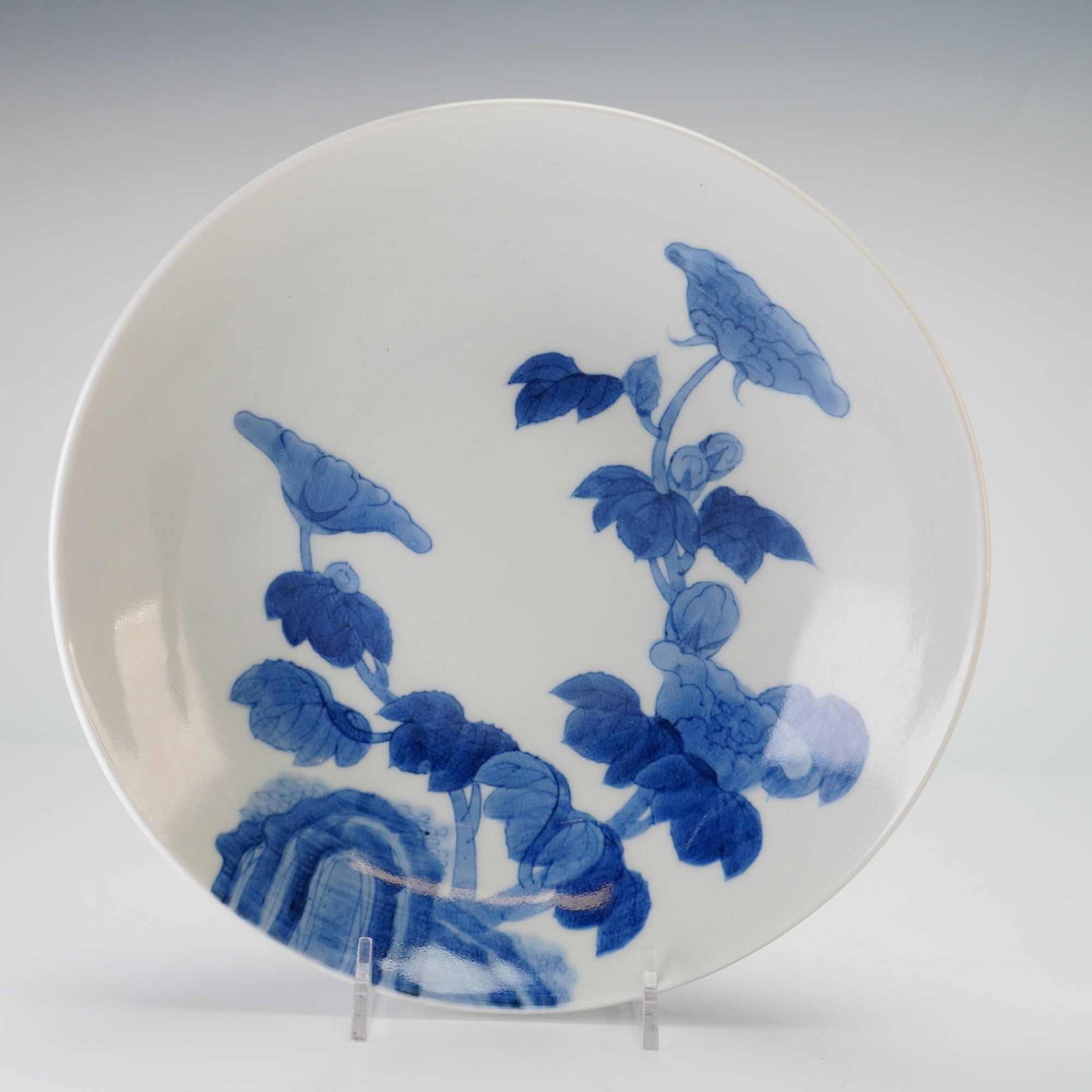 Japanese Nabeshima Blue and White Porcelain Dish, Flowers and Coins Designs: A Japanese Nabeshima blue and white porcelain bowl featuring blooming floral decorations on the interior and coin motifs on the exterior. Dimensions 2"H x 8.25" dia. Weight 1.60 lb
