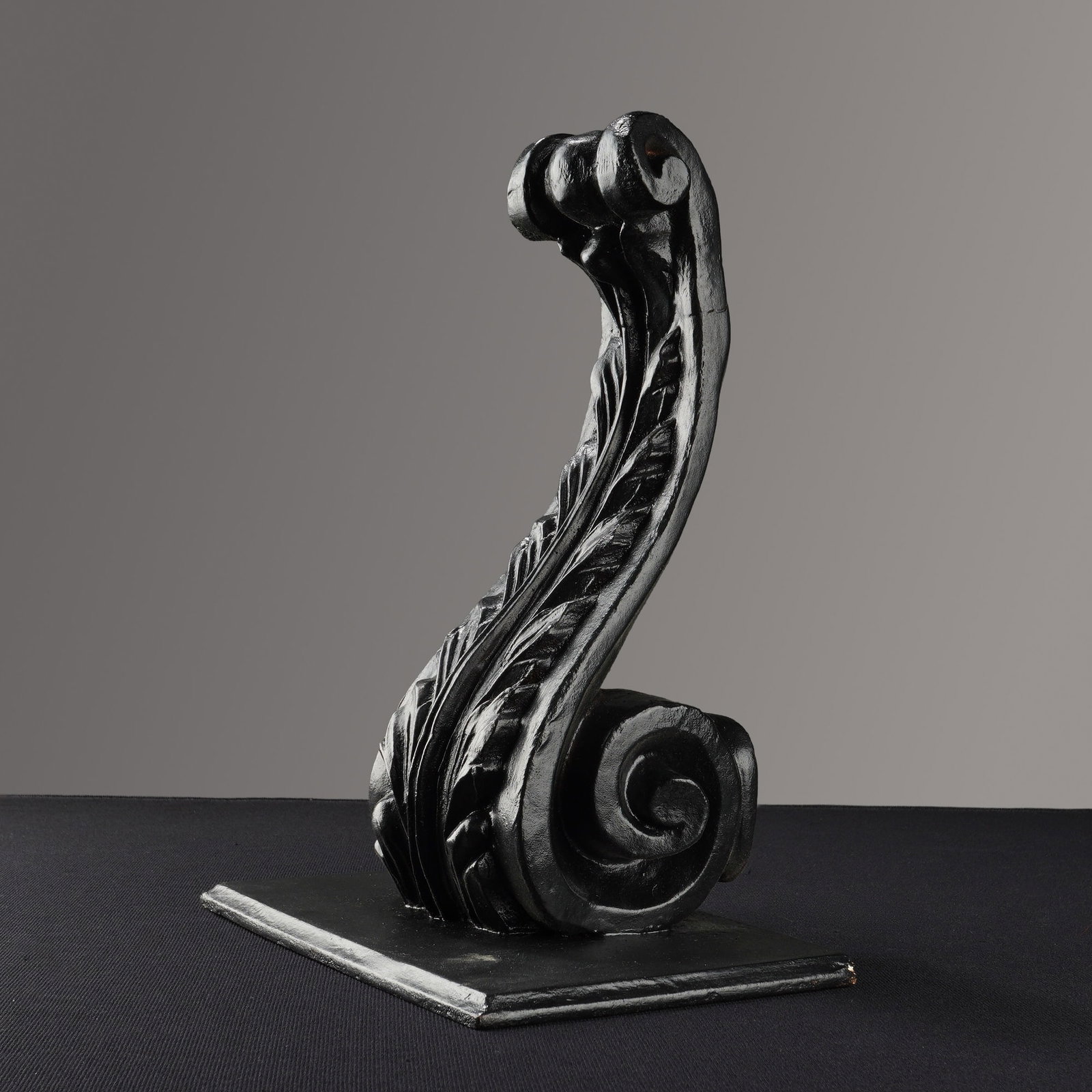 Italian Black Carved Wood Acanthus Corbel: This black carved wood corbel is designed in a neoclassical architectural style featuring a scrolling acanthus leaf. The piece is finished with a matte black paint and is mounted to a rectangular