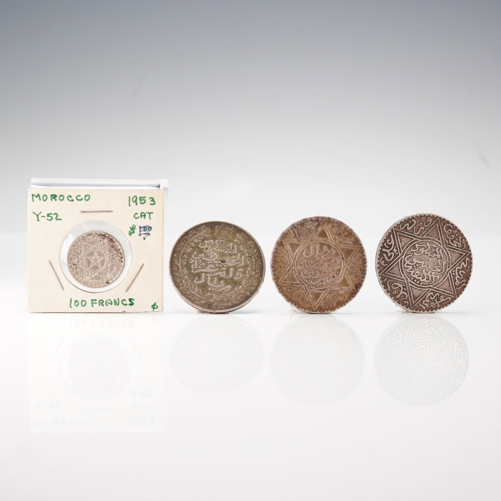 4pc MAROC Coin Group 1953 100 Francs & Dirhams AH 1299, 1329, 1336: This four piece group consists of Moroccan silver coinage spanning the late 19th to mid 20th century, including Islamic calendar issues dated AH 1299, AH 1329, and AH 1336 in mixed denominations that 