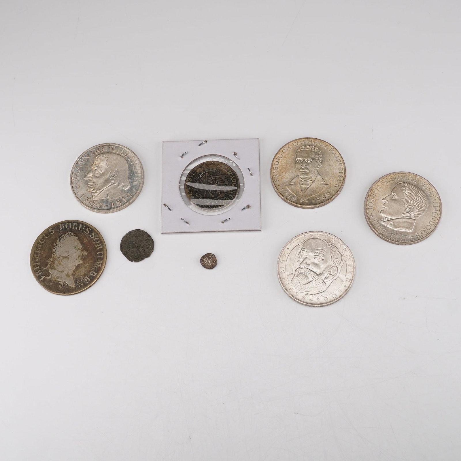 8pc Hungarian, Indian, & German 1387 to 1968 Coins: Including a small medieval hammered coin attributed to Hungary dated circa 1387 with stylized geometric motifs and Latin inscriptions; an early Indian punch-marked silver coin showing traditional symb