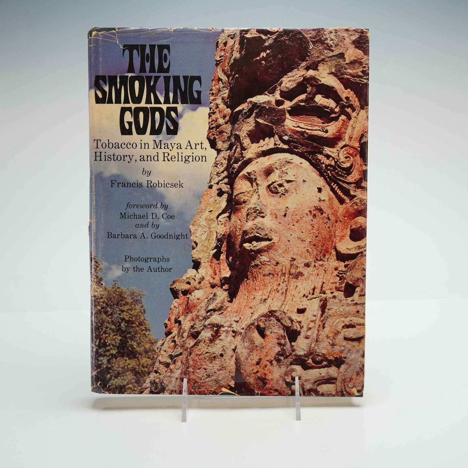 Francis Robicsek Hardcover Book, The Smoking Gods: A first edition hardcover copy of The Smoking Gods: Tobacco in Maya Art, History, and Religion by Francis Robicsek, published by the University of Oklahoma Press in 1978. The volume features a forewor