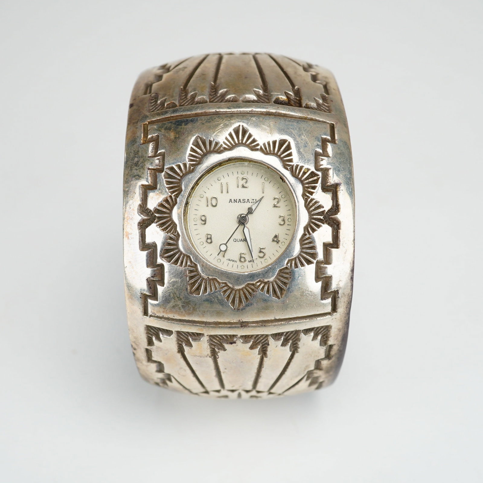 Navajo Ken & Mary Bill Sterling Silver Native American Cuff Watch: This handcrafted Navajo sterling silver cuff watch features a timepiece by Anasazi. The wide cuff is constructed of sterling silver and decorated with traditional hand-stamped geometric patterns, incl