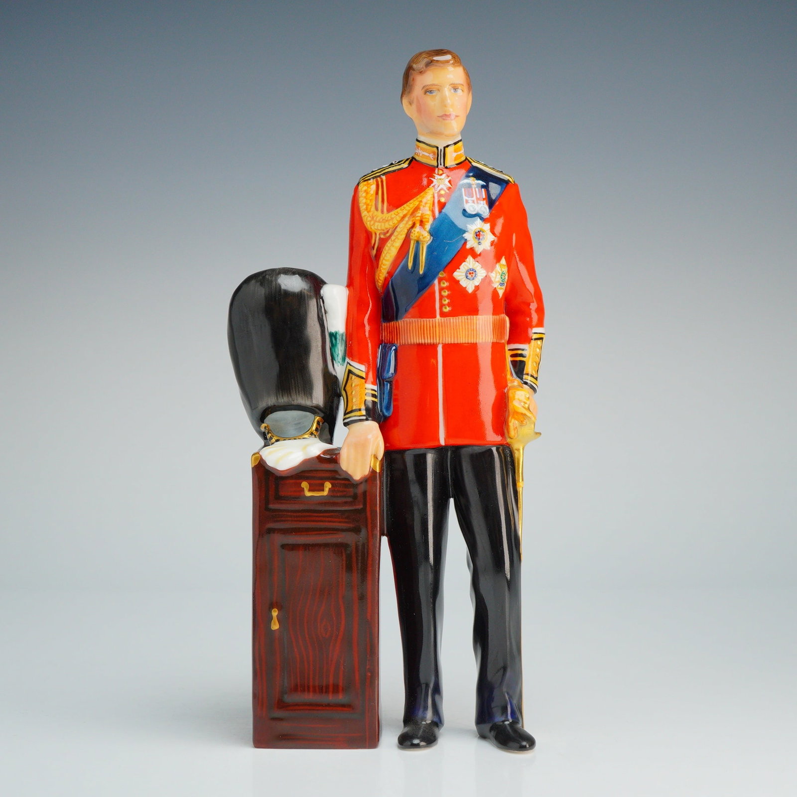 Royal Doulton HRH The Prince of Wales HN2884 Limited Edition Figurine: A Royal Doulton fine bone china figurine, model HN2884, depicting HRH The Prince of Wales in full-dress military uniform. The figure is modeled wearing a red tunic with gold-tone detailing, a blue sas
