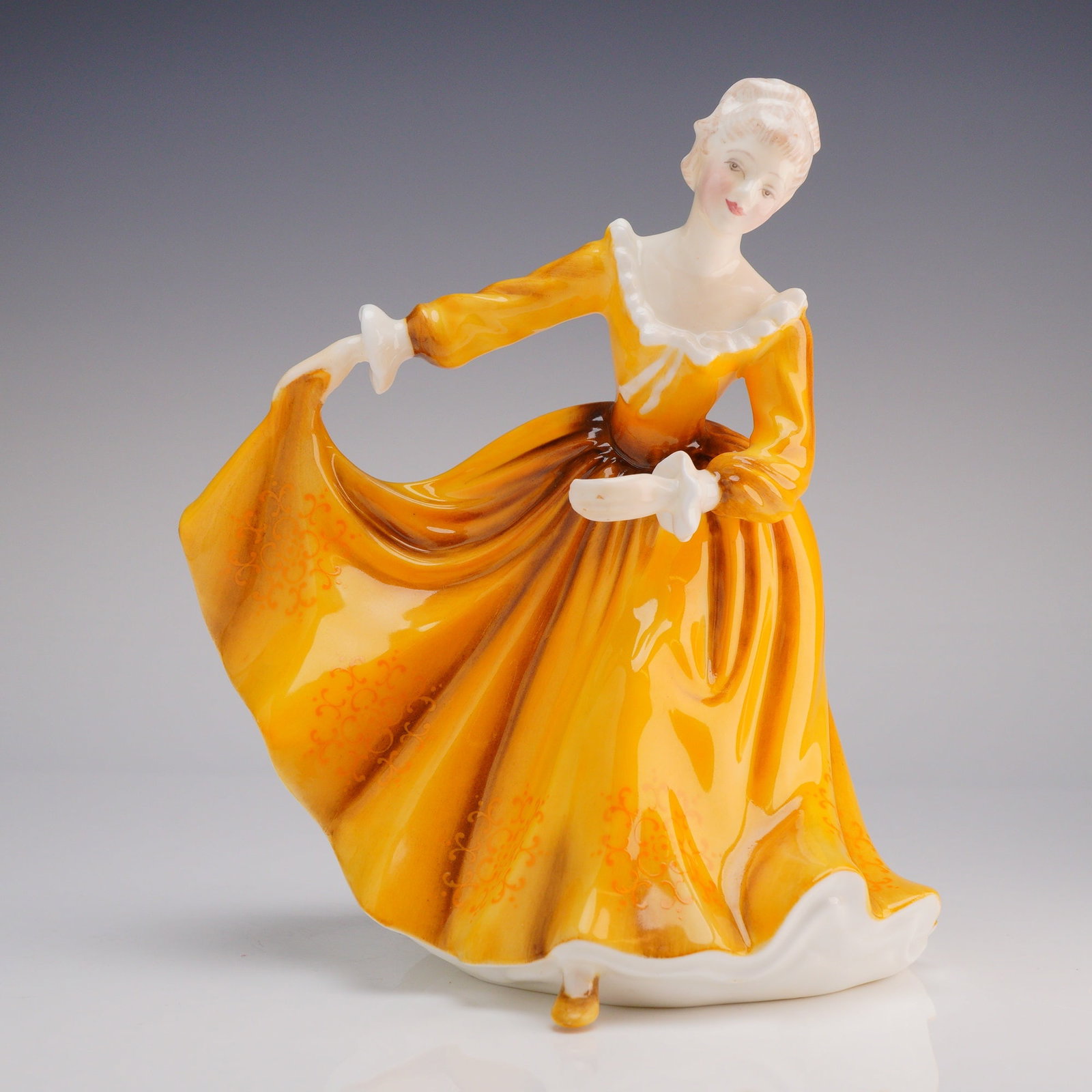 Royal Doulton Figurine Kirsty HN 2381: The figure depicts a young woman in a stylized Georgian or Victorian-era formal gown, posed mid-curtsy or dance, holding the skirt of her dress aloft. The dress is finished in a highly saturated, glos
