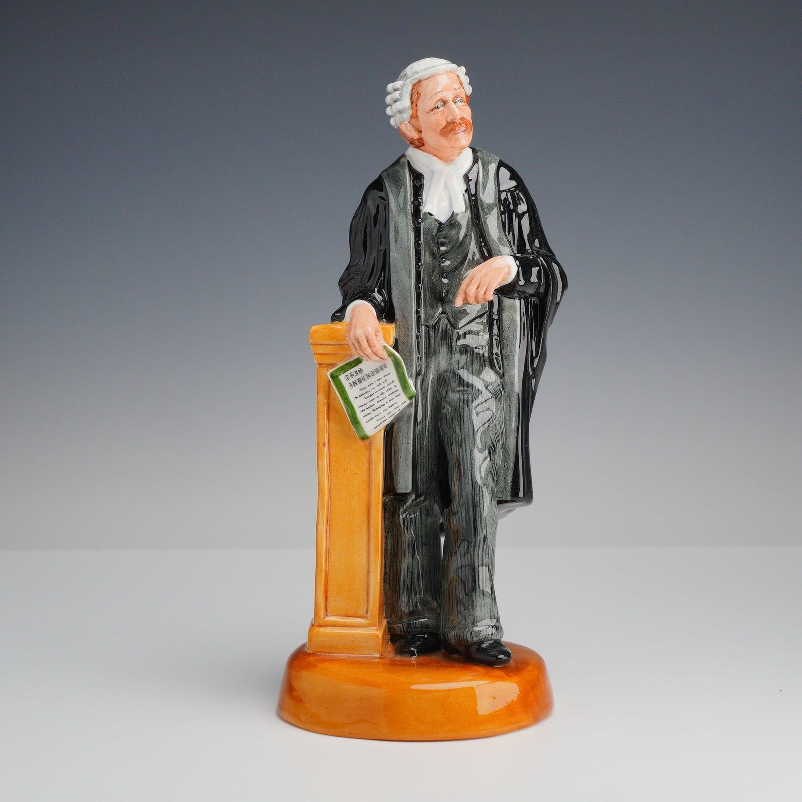 Royal Doulton Porcelain Figurine, The Lawyer HN3041: This Royal Doulton bone china figurine, titled The Lawyer and designated as model HN 3041, was designed by Peter Parsons. The figure depicts a male barrister in traditional British legal attire, inclu