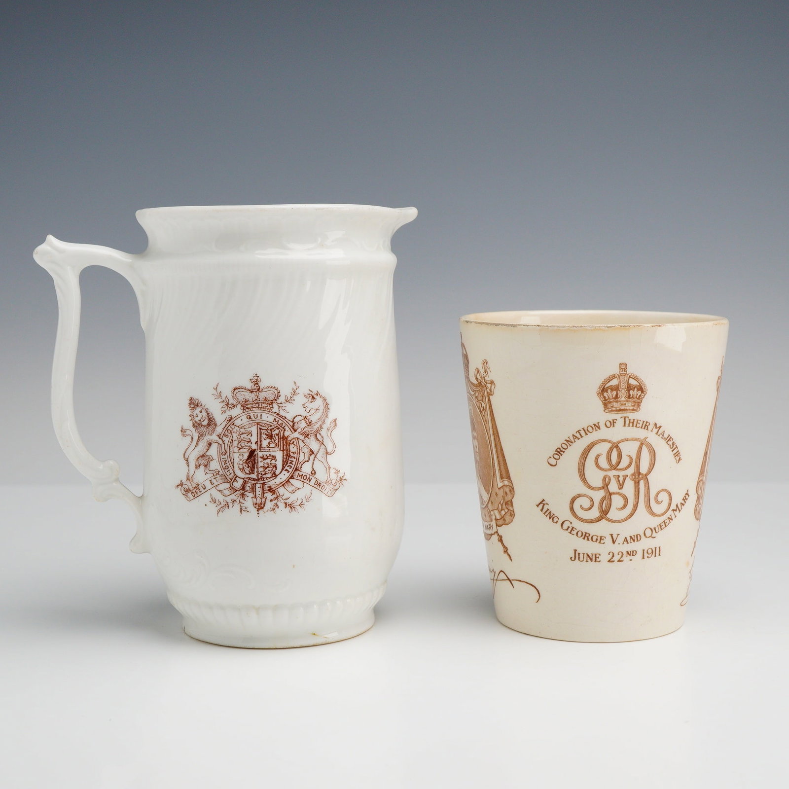 2pc British Royal Commemorative Ceramics Including a Royal Doulton 1911 Coronation Beaker: This lot consists of two ceramic items relating to George V and Queen Mary. The first item is a Royal Doulton cream-colored earthenware beaker produced for the coronation on June 22, 1911. The decorat