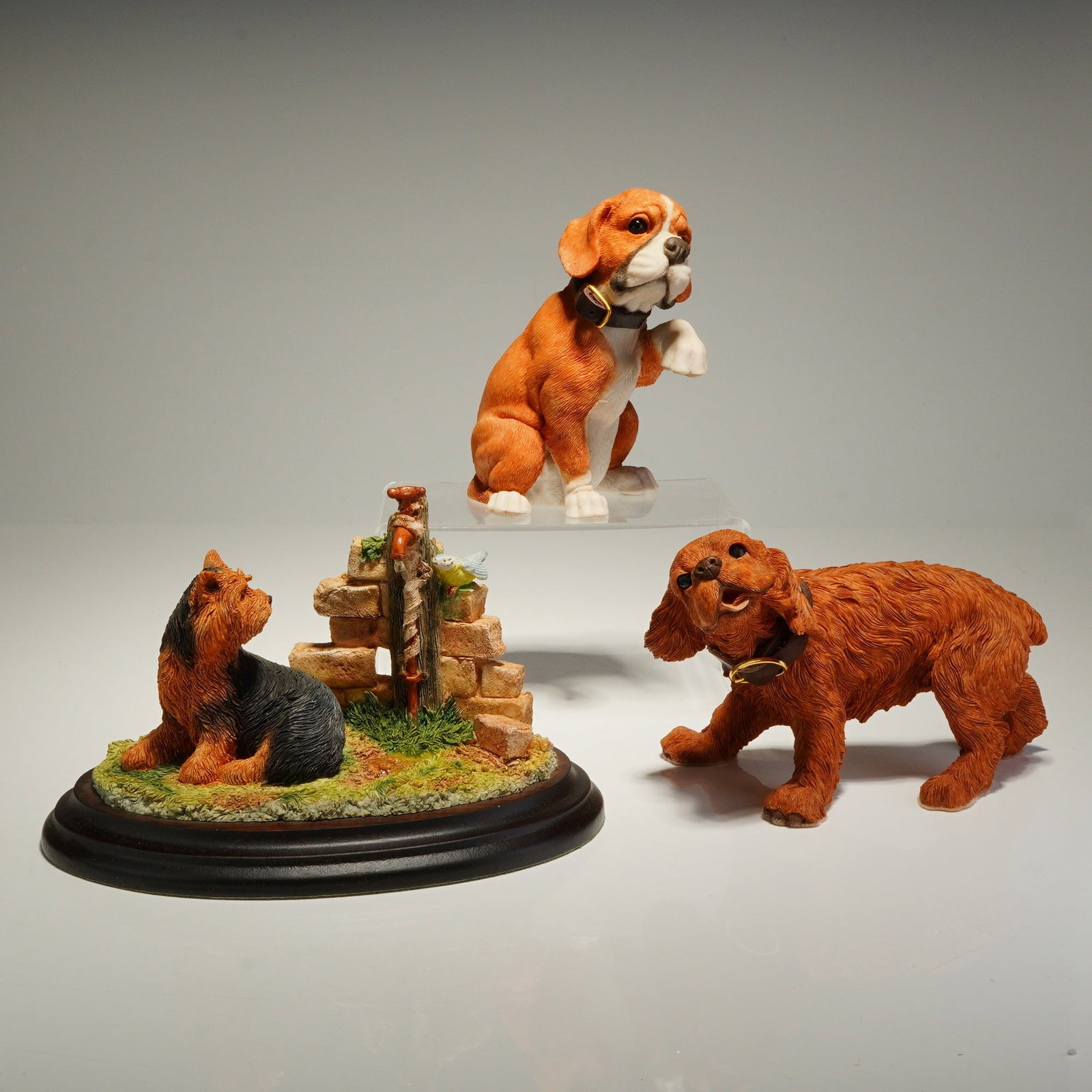 3pc Country Artists and Barkers Resin Dog Figurines: The collection includes one Country Artists figurine titled Yorkshire Terrier/Tap, model number 01144, featuring a terrier seated beside a brick wall with a water tap and a bird. This piece is signed 