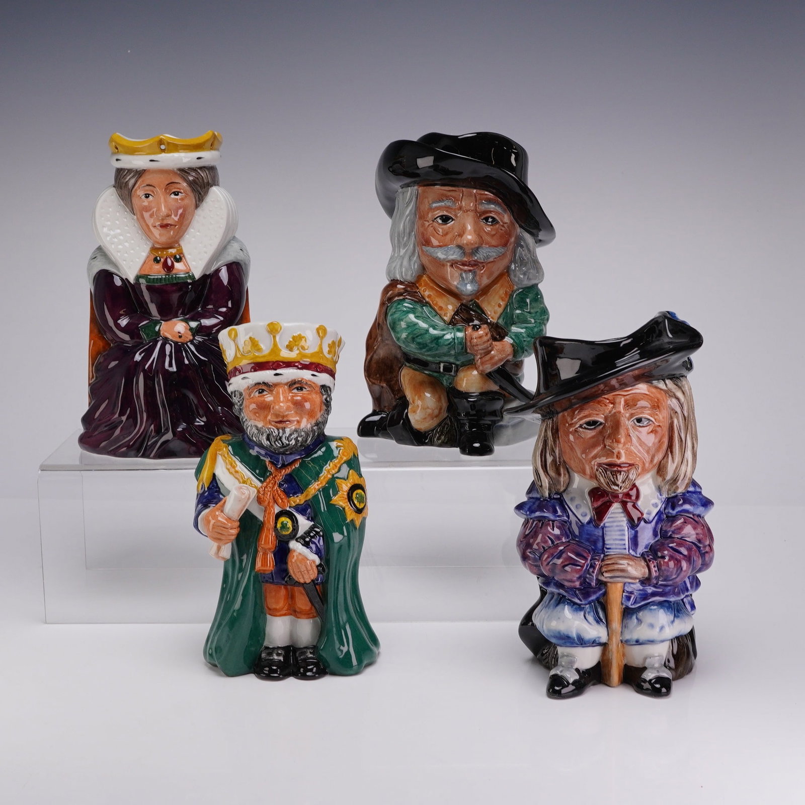 4pc Staffordshire Fine Ceramics Hand Painted Toby Jugs: This set consists of four hand-painted earthenware Toby jugs produced by Staffordshire Fine Ceramics in England. The collection includes figures identified as a Queen in Elizabethan-style dress with a