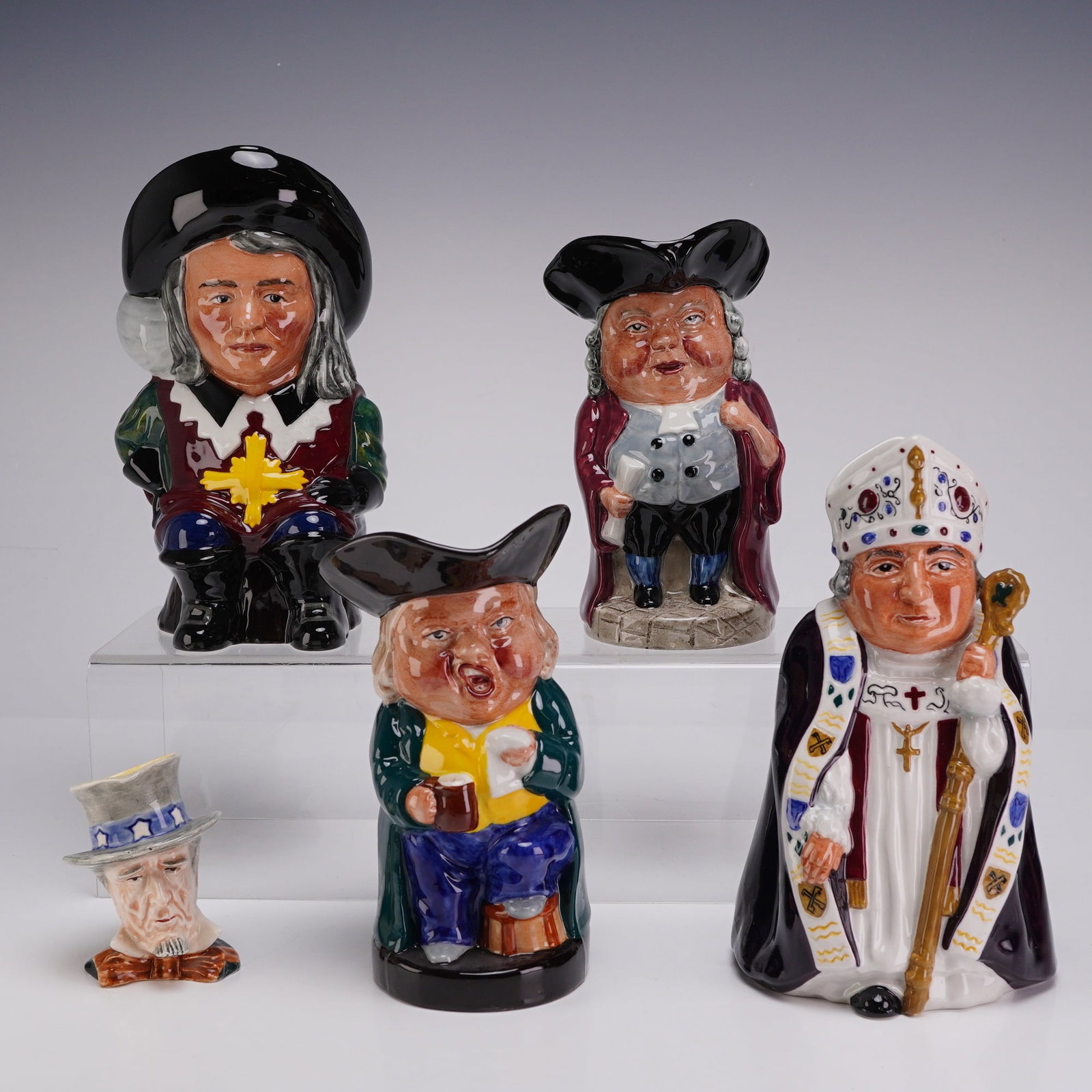 5pc Staffordshire Fine Ceramics and Royal Winton Toby Jugs: A collection of five English glazed earthenware Toby jugs, comprising four large examples by Staffordshire Fine Ceramics and one miniature example by Royal Winton. The Staffordshire pieces include D A
