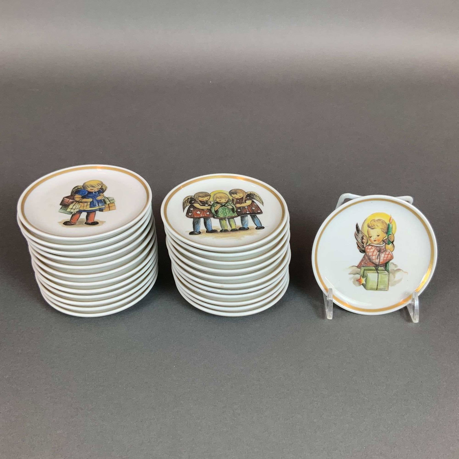Collection of 24 Berta Hummel Museum Miniature Plates by Schmid: A collection of 24 miniature porcelain collector plates from the Berta Hummel Museum Miniature Plate Collection. These pieces feature reproductions of illustrations inspired by the art of Berta Hummel