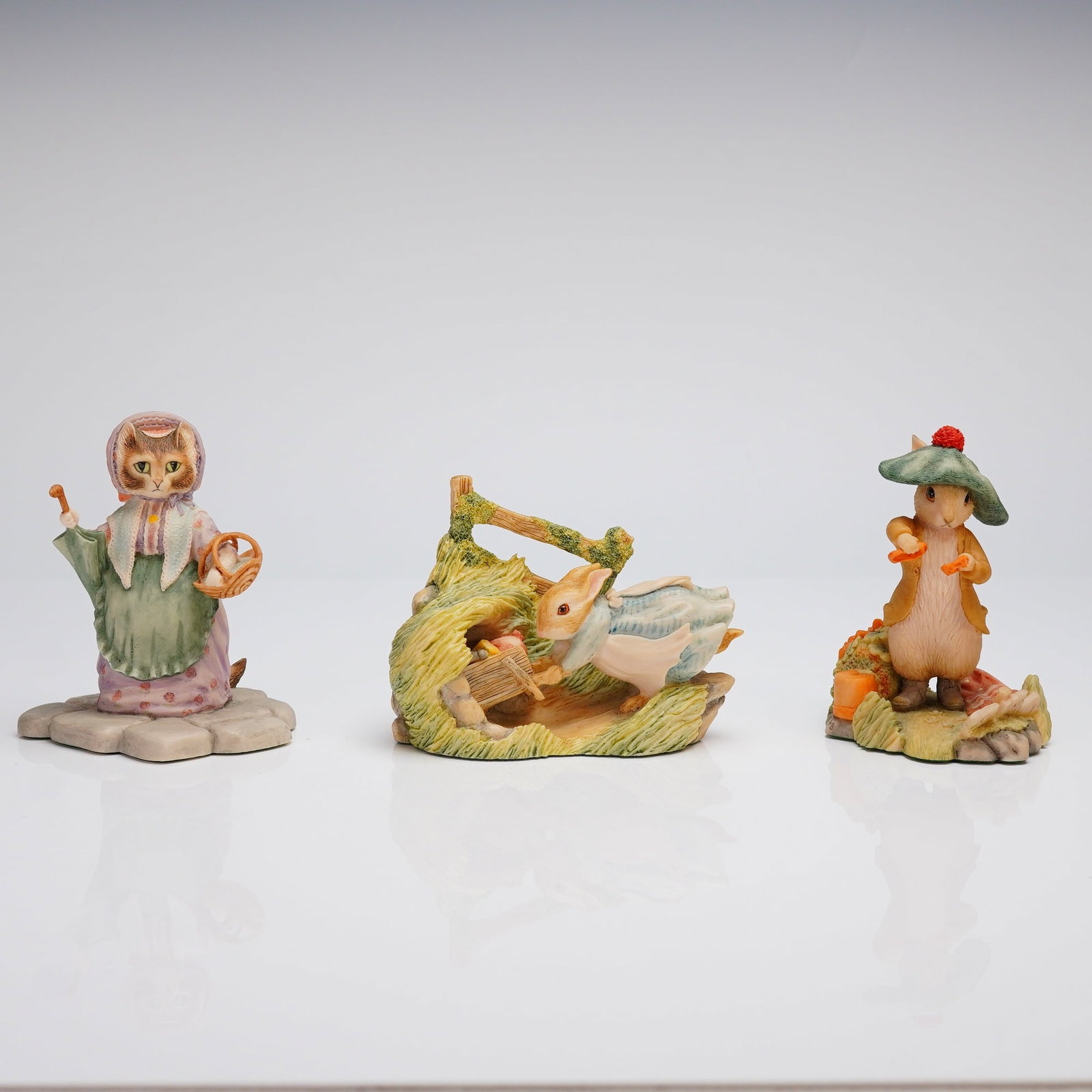 3pc Border Fine Arts The World of Beatrix Potter Figurines: A collection of three items by Border Fine Arts, depicting characters from The World of Beatrix Potter. The lot of figurines includes Benjamin Bunny, Cecily Parsley Ran Away, and Cousin Ribby. Each it