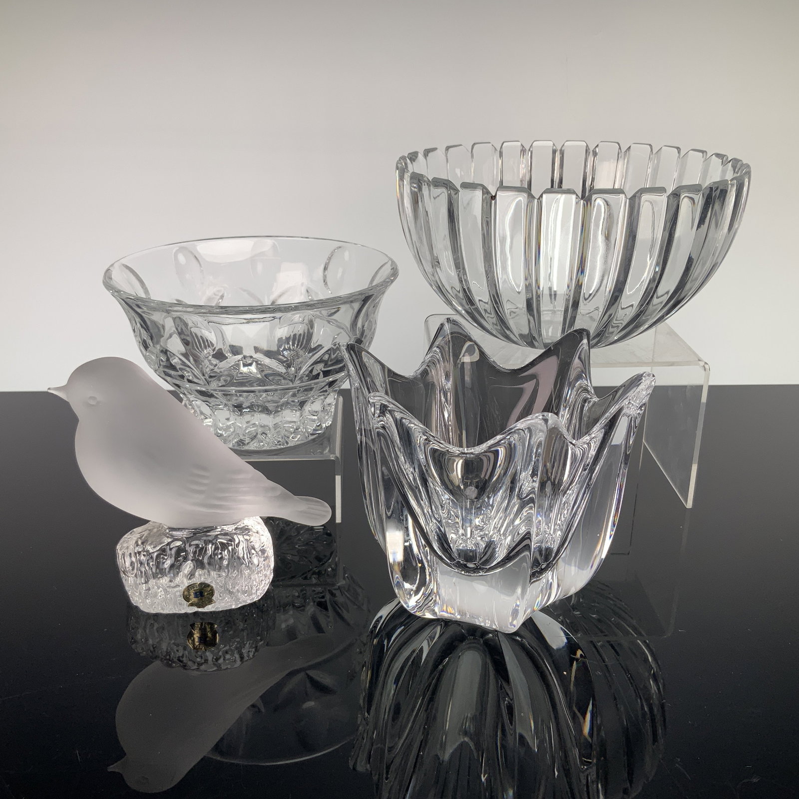 4pc Crystal Bowls & Figurine Including Orrefors, Holmegaard, Reijmyre, and Block Crystal: This collection consists of four pieces of fine art glass and decorative crystal, featuring prominent Scandinavian and traditional designs. The group includes an Orrefors crystal bowl in the Belle Tul